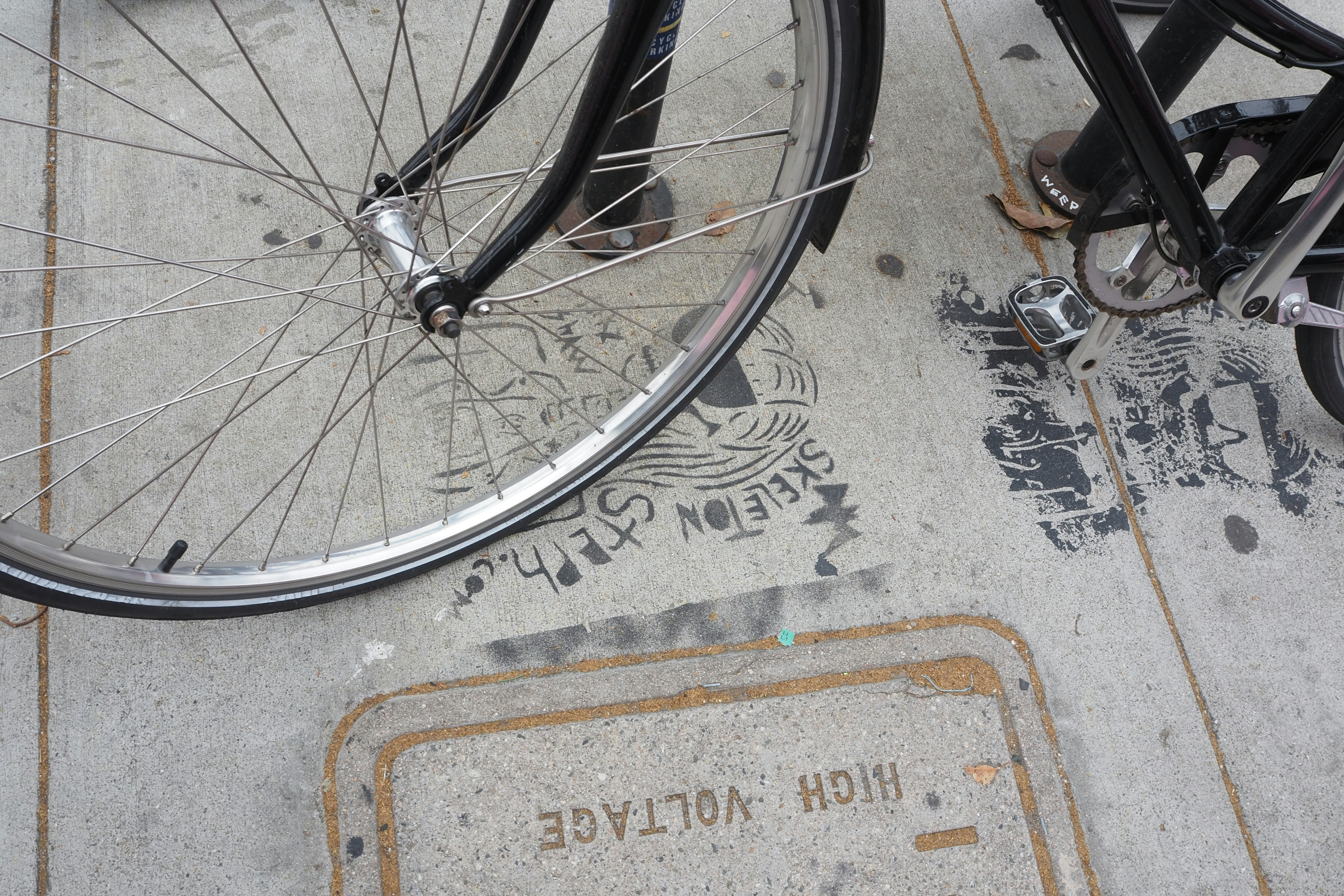 自転車の車輪と舗装された歩道の一部が写っている画像