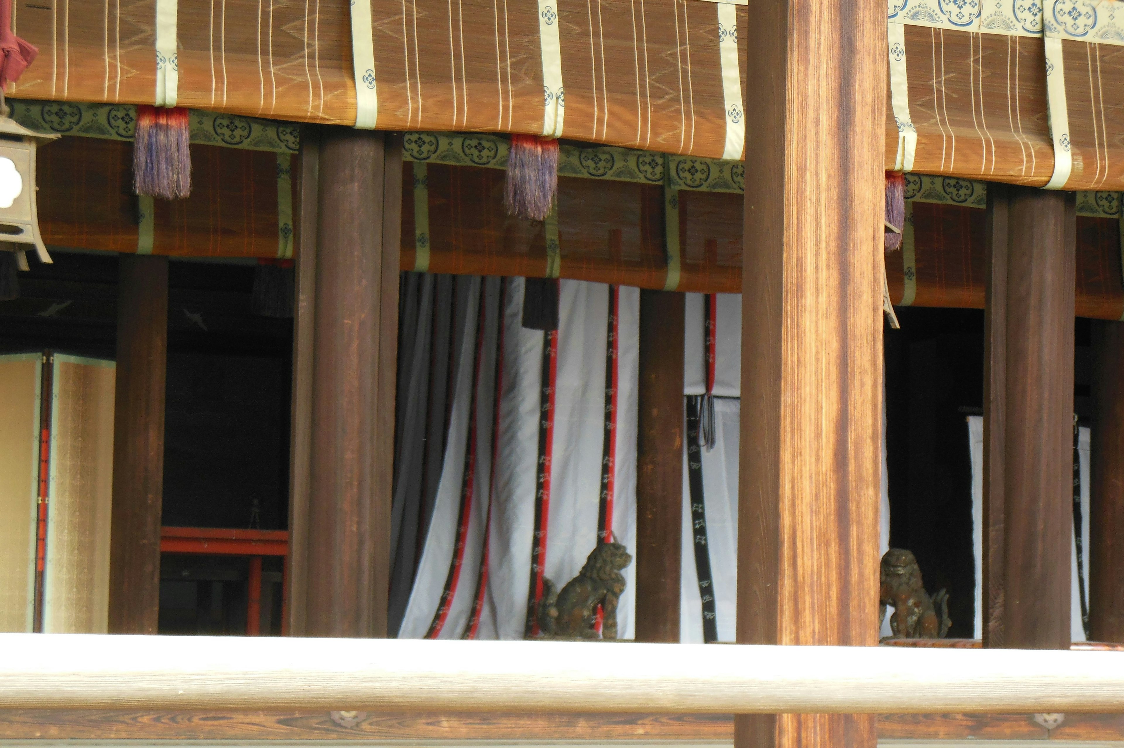 View of a traditional building featuring wooden pillars and decorative fabric