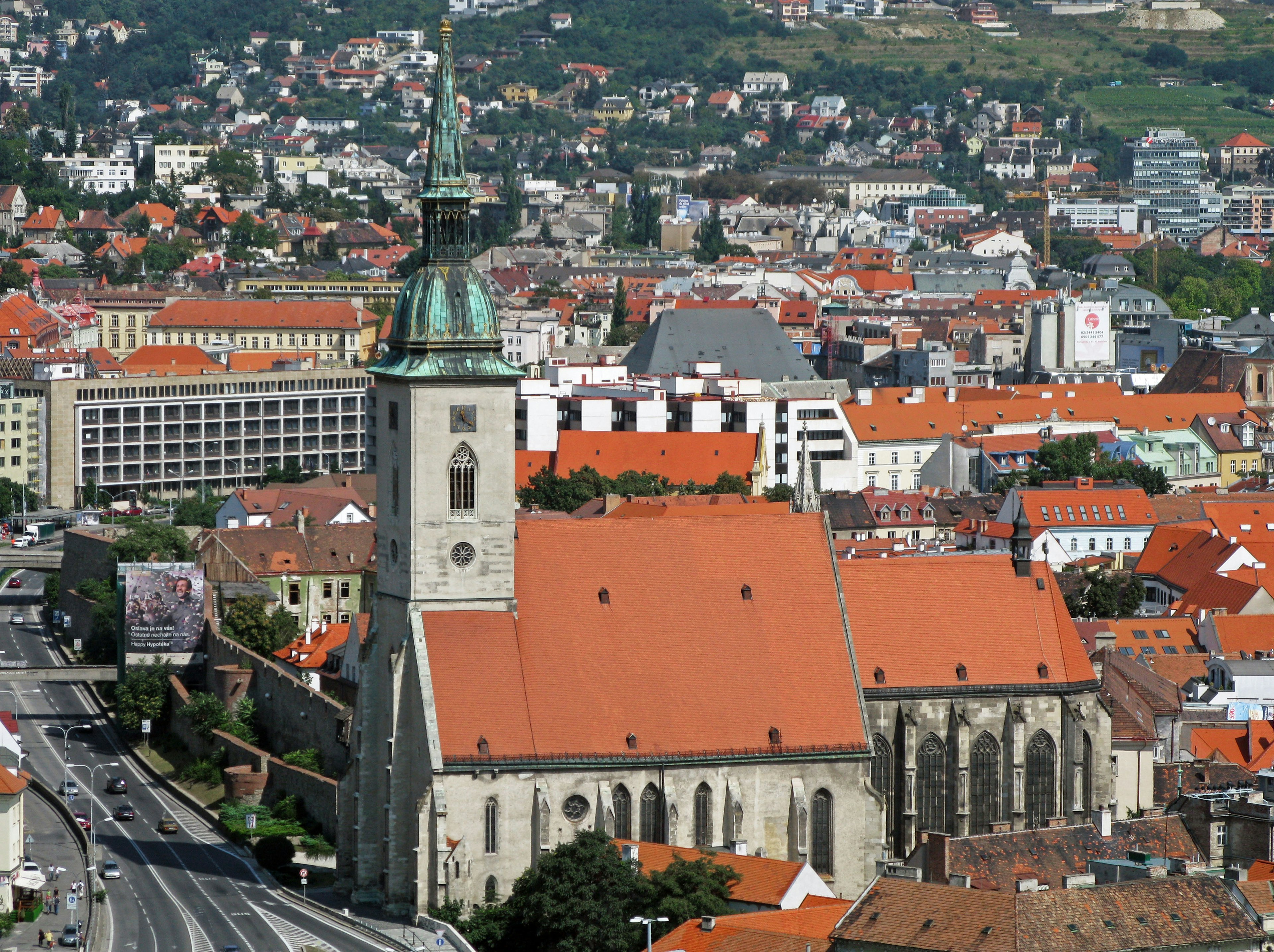 A large church amidst a cityscape with orange rooftops