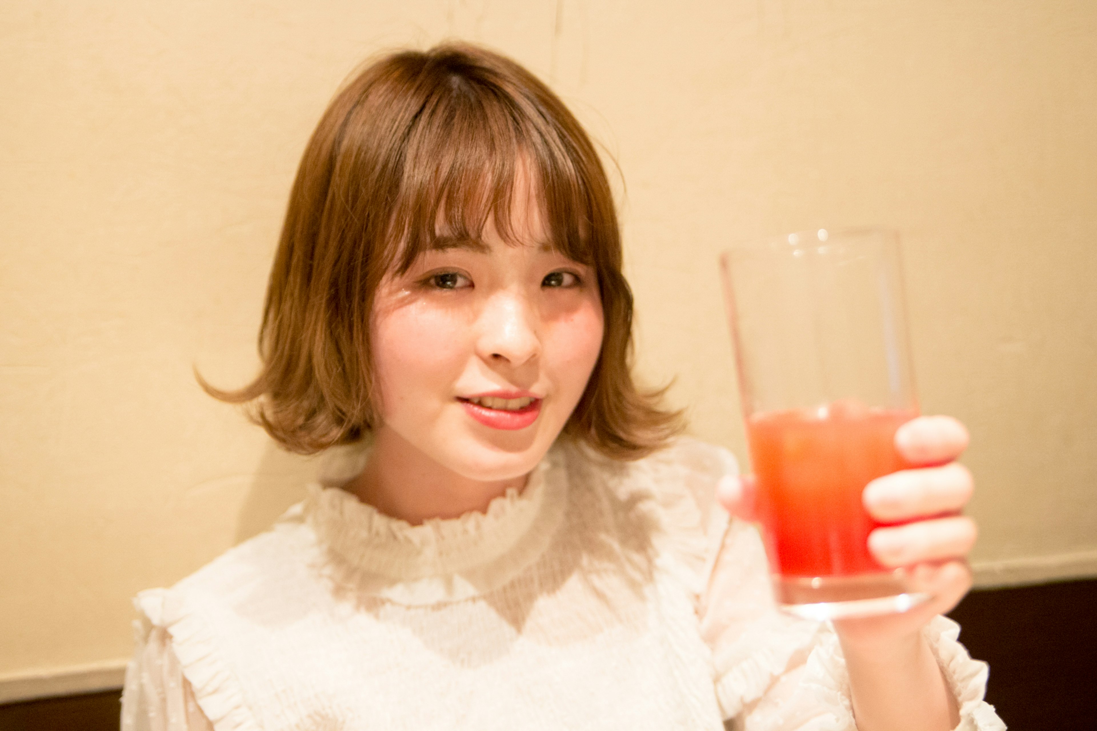 Young woman smiling while holding a drink