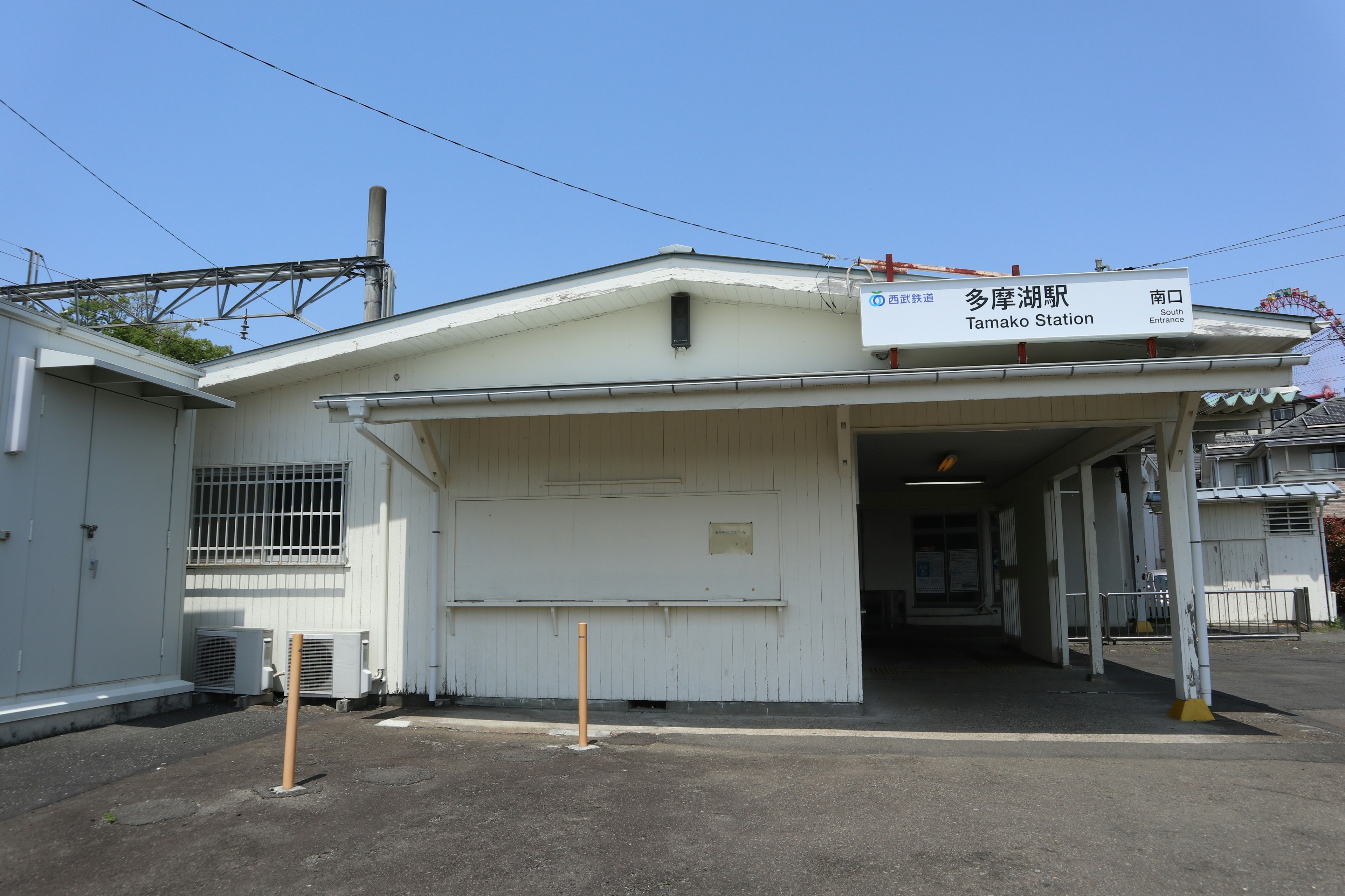 白い外壁の駅舎と青空