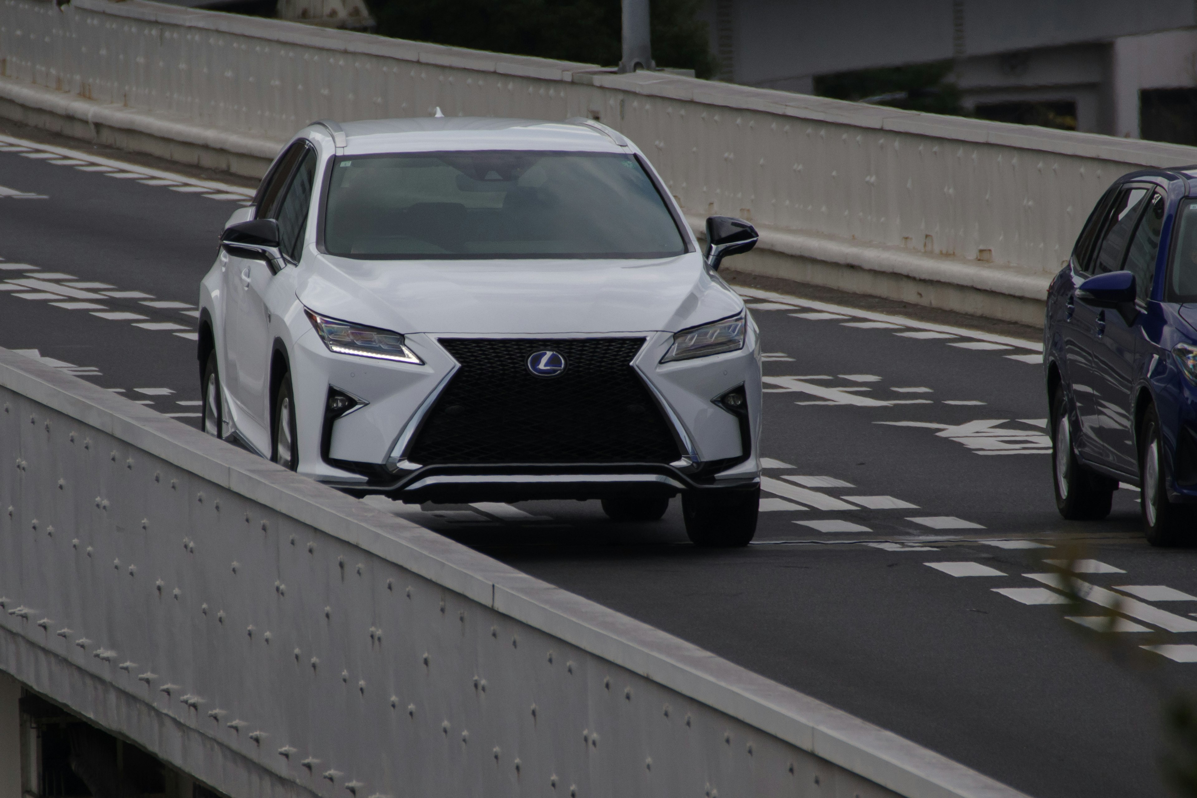 White Lexus SUV driving on a highway