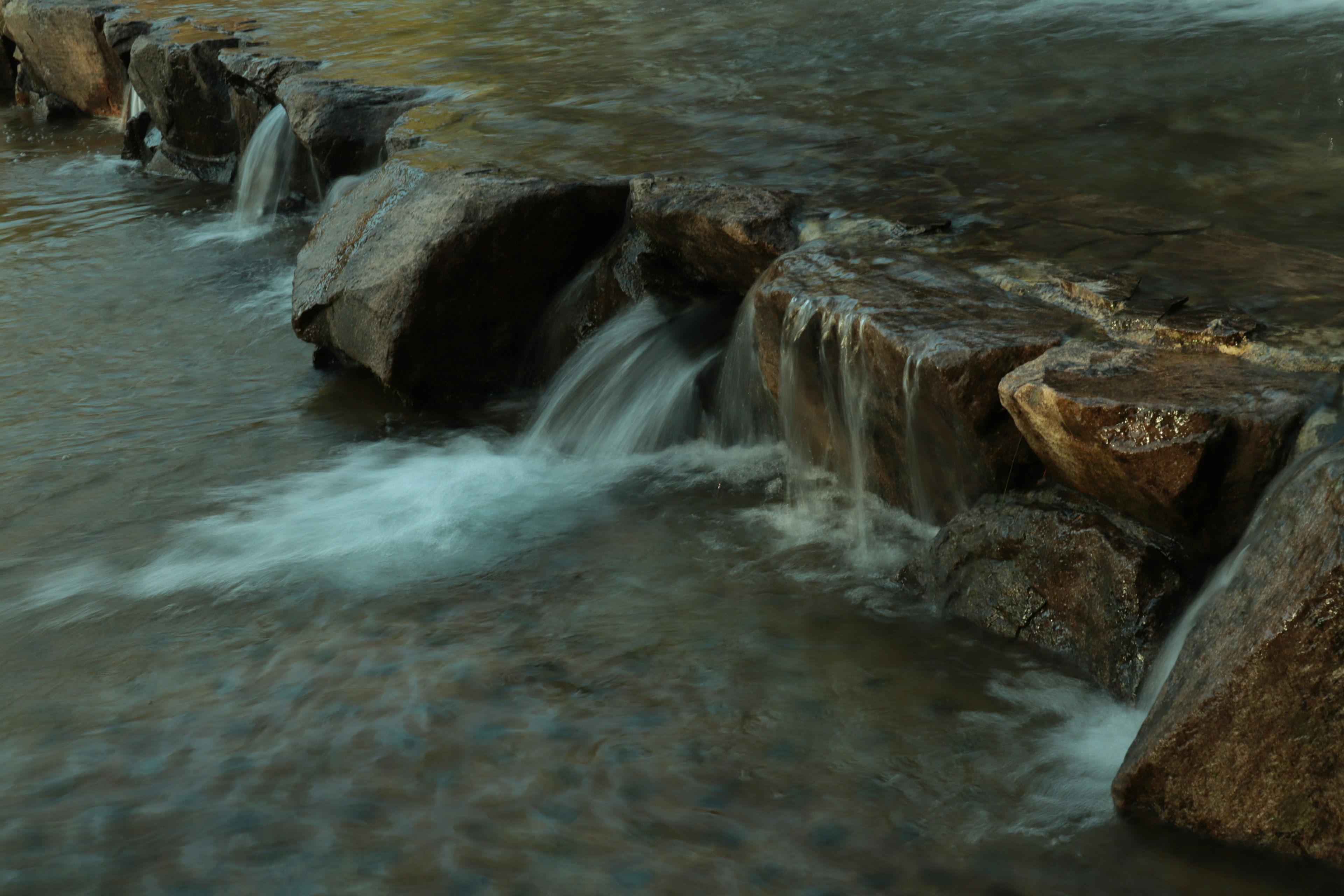 A serene view of flowing water over rocks