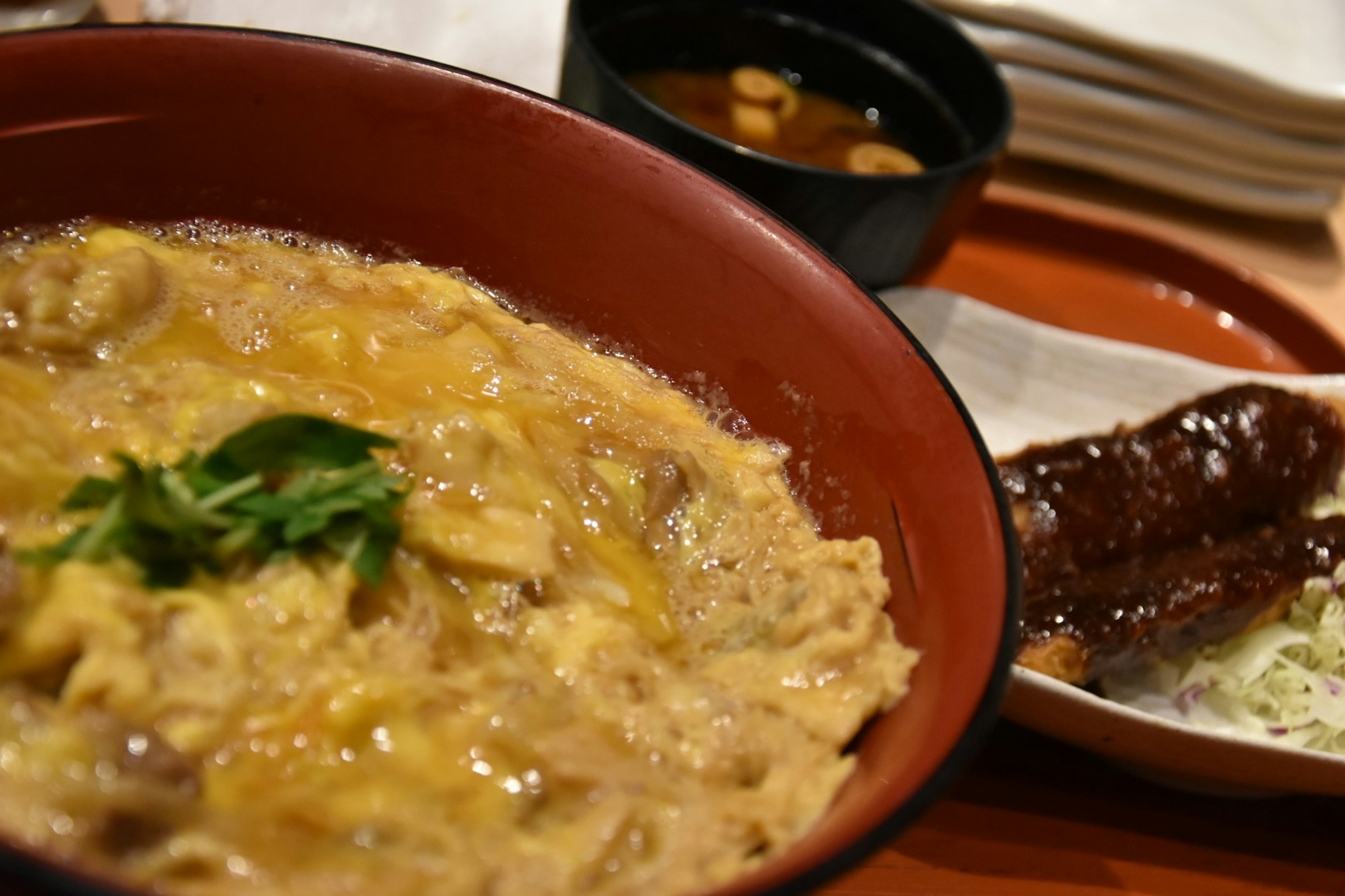 Delicious oyakodon served with a side dish and soup