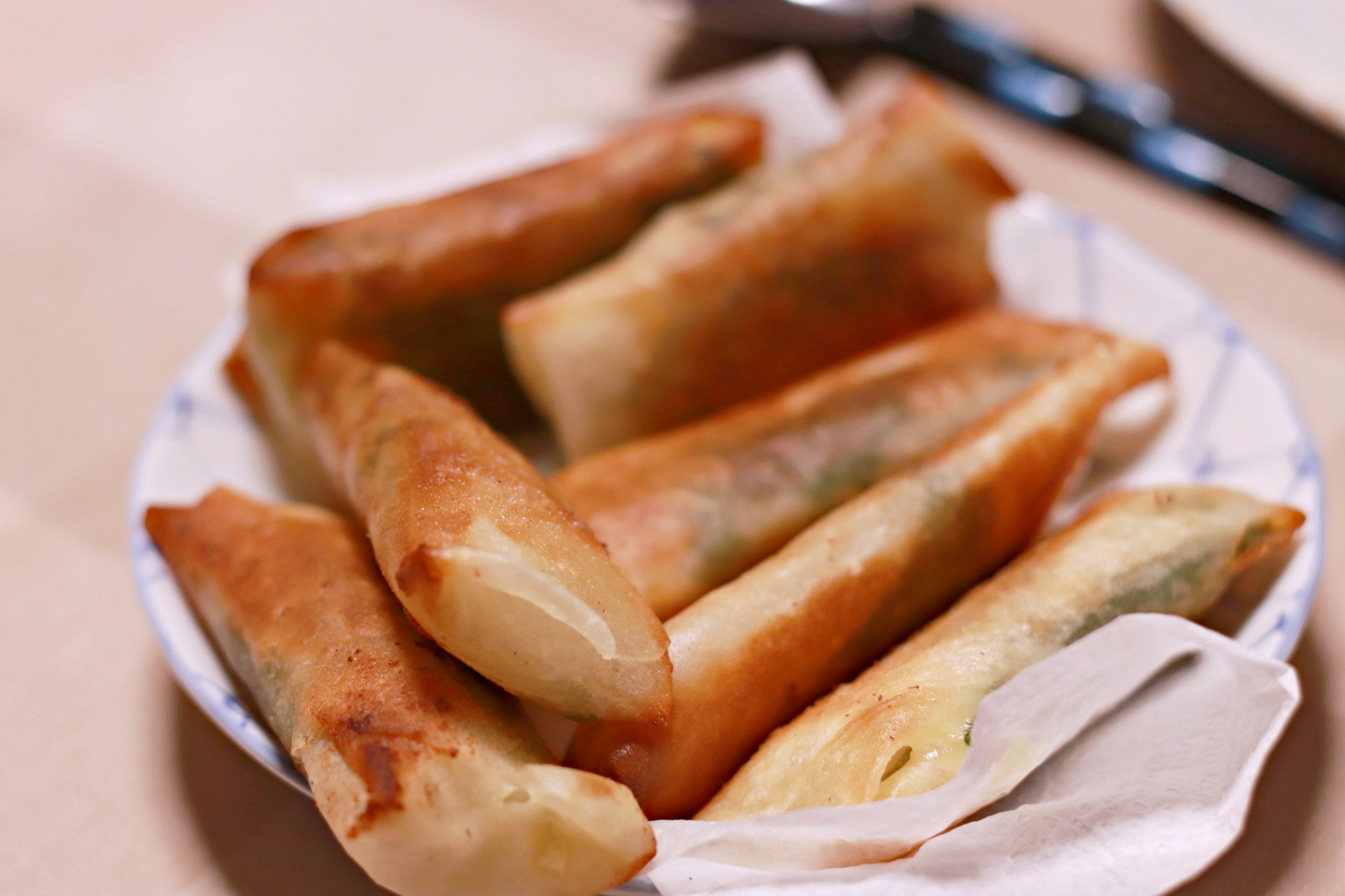 A plate of crispy spring rolls arranged neatly