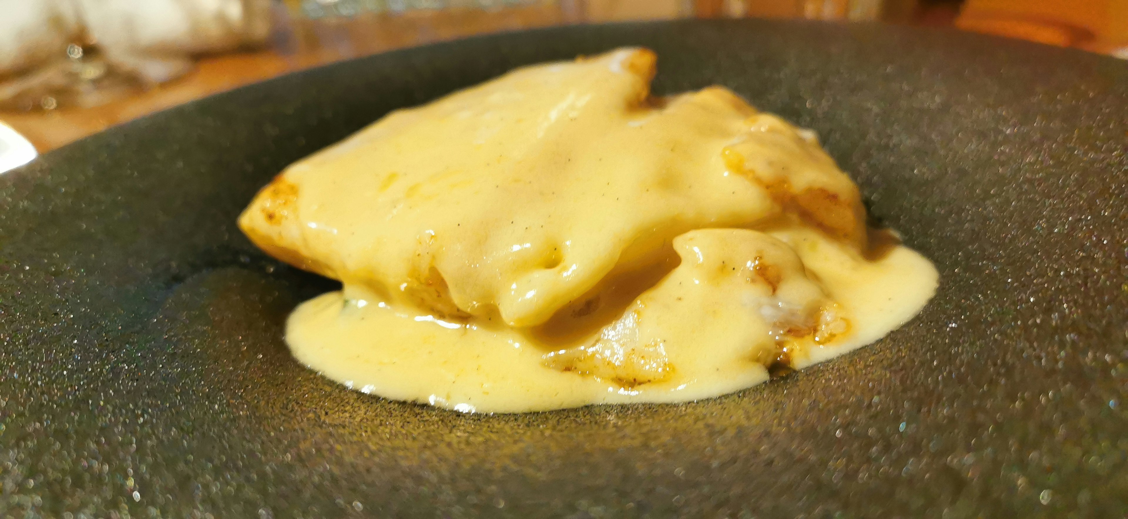 Dish with creamy sauce on a black plate