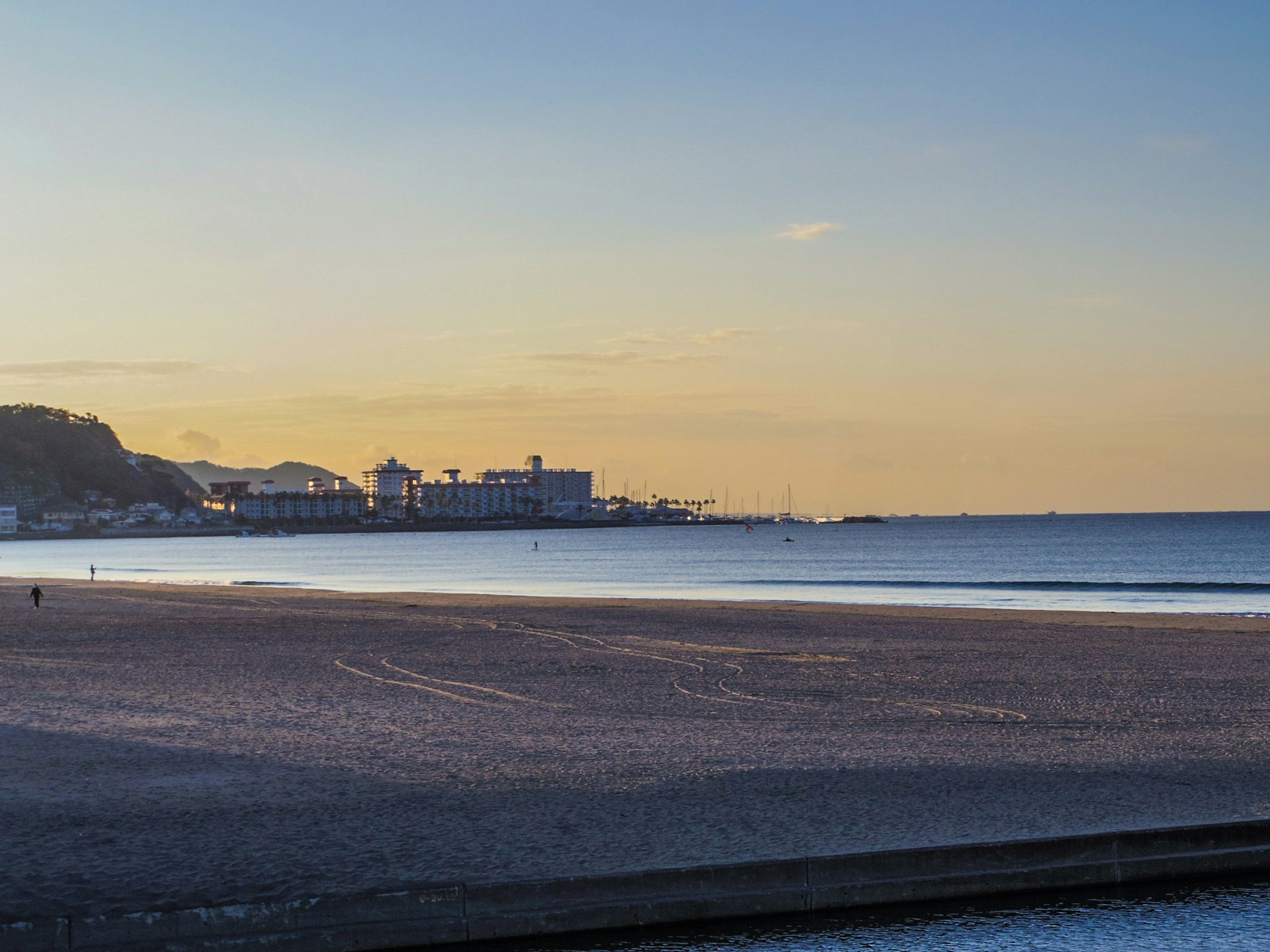 Serene beach view with sunset and coastline