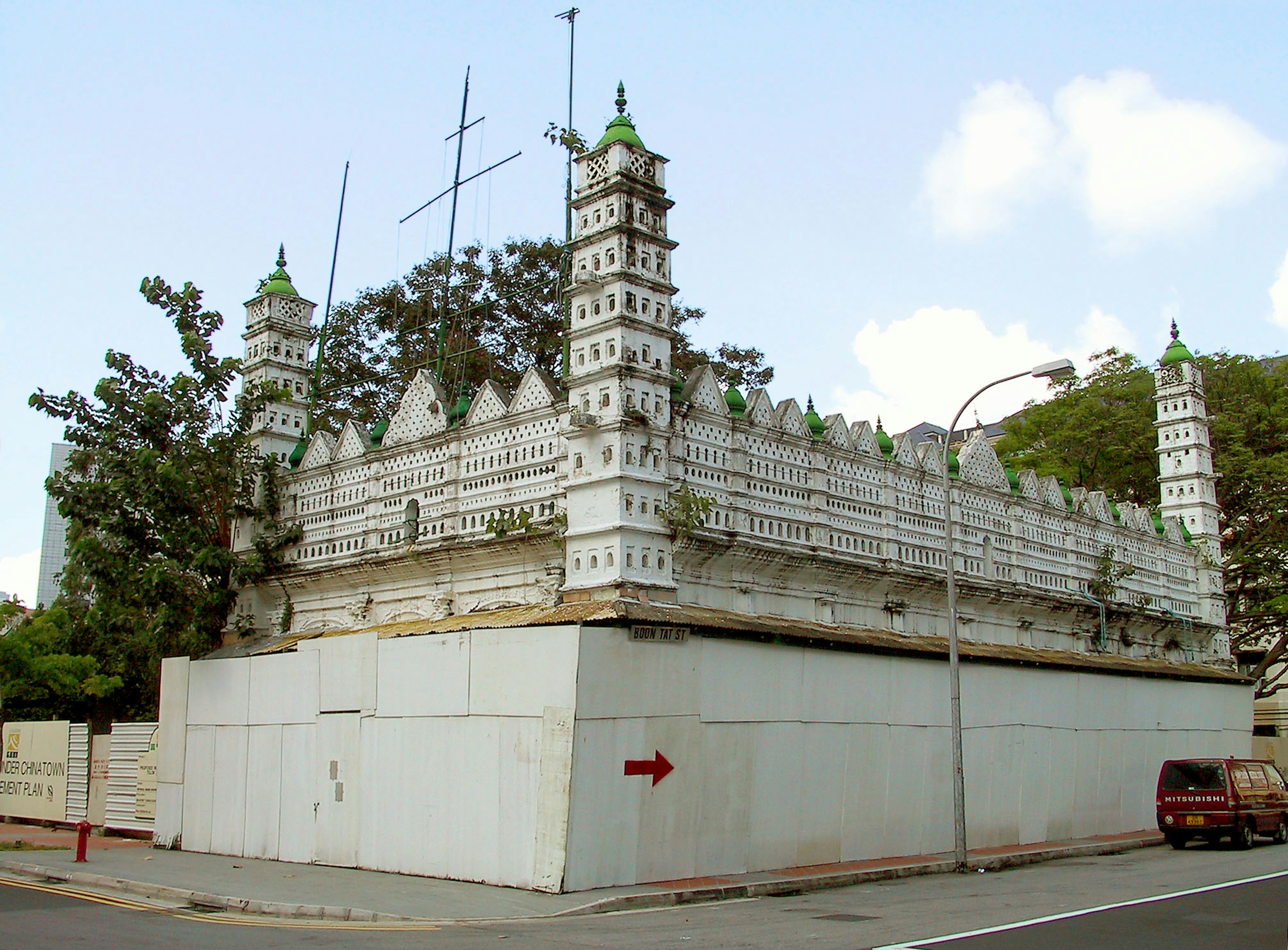 Historic building with white walls and green domes