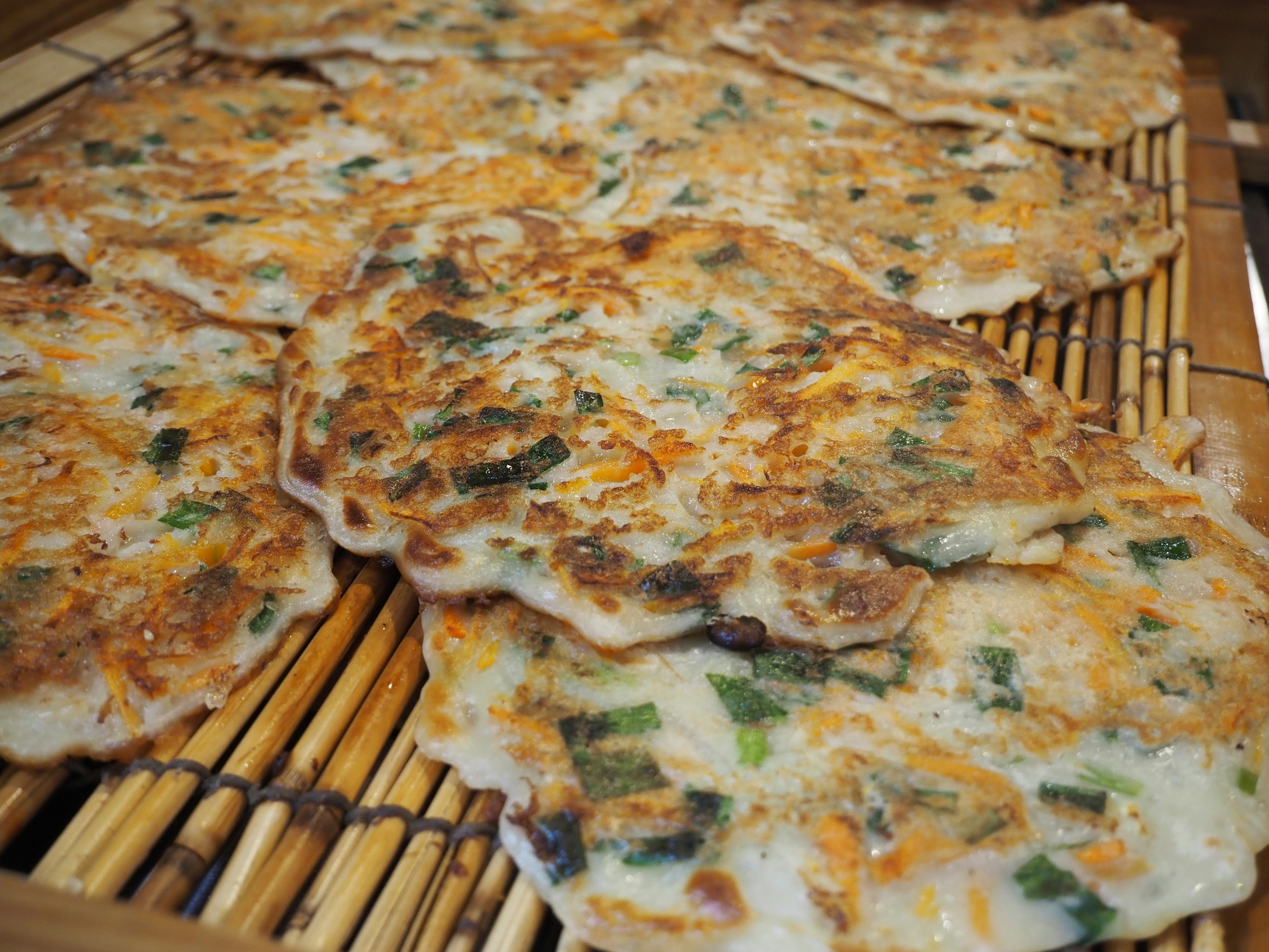 Delicious Korean pancakes arranged on a bamboo mat