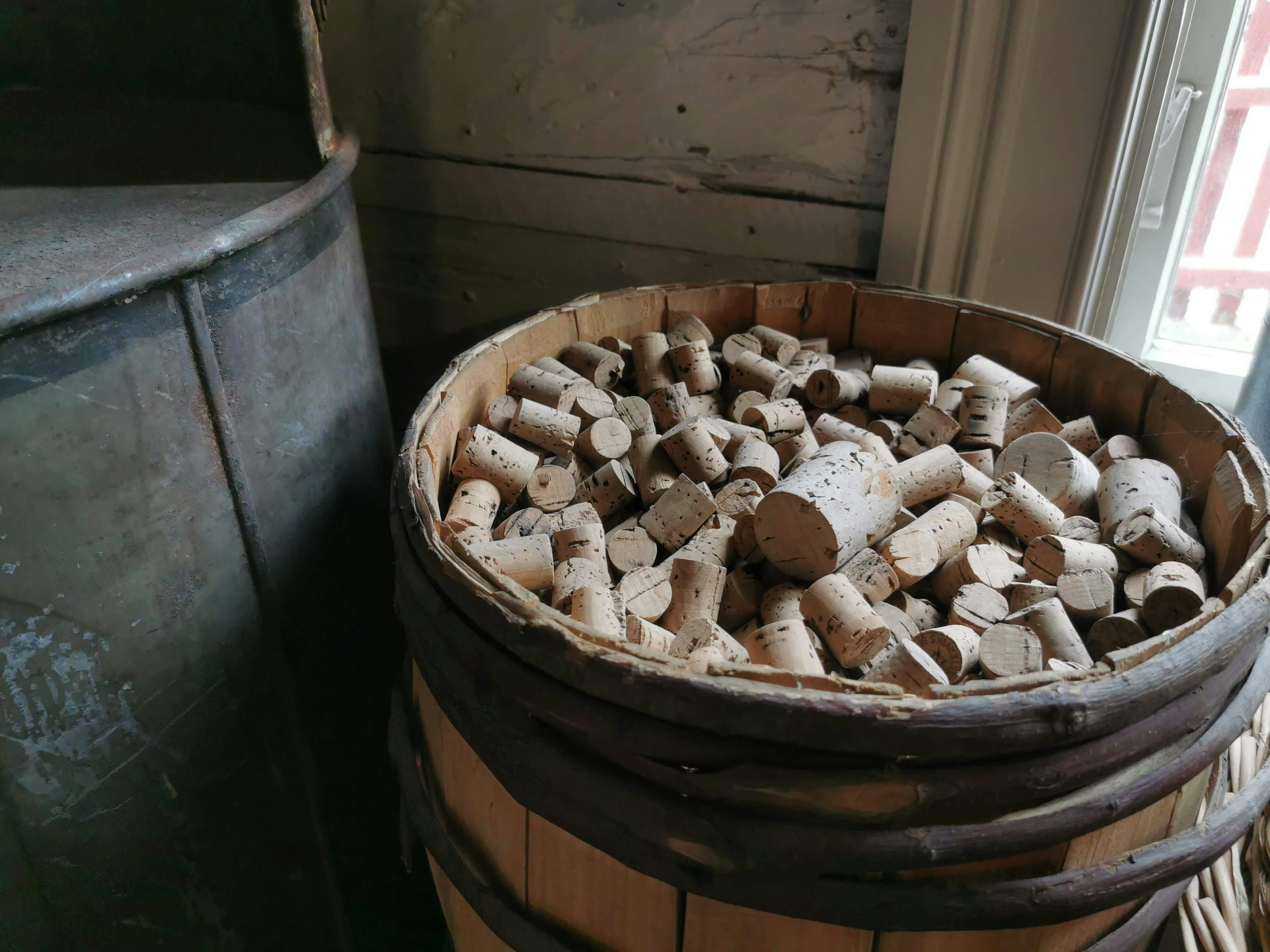 A basket filled with wooden corks stacked neatly