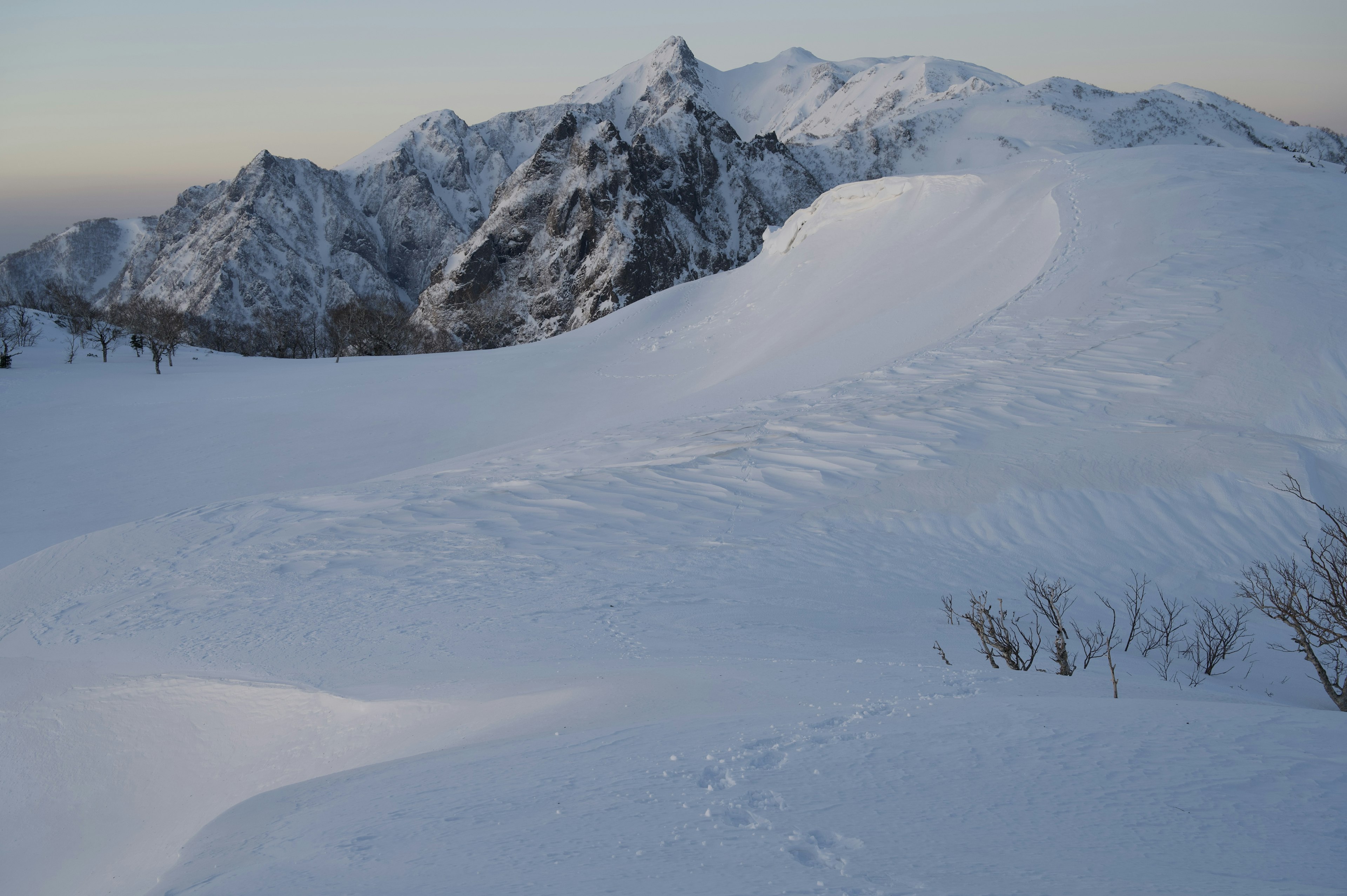 Snow-covered mountain landscape with blue sky