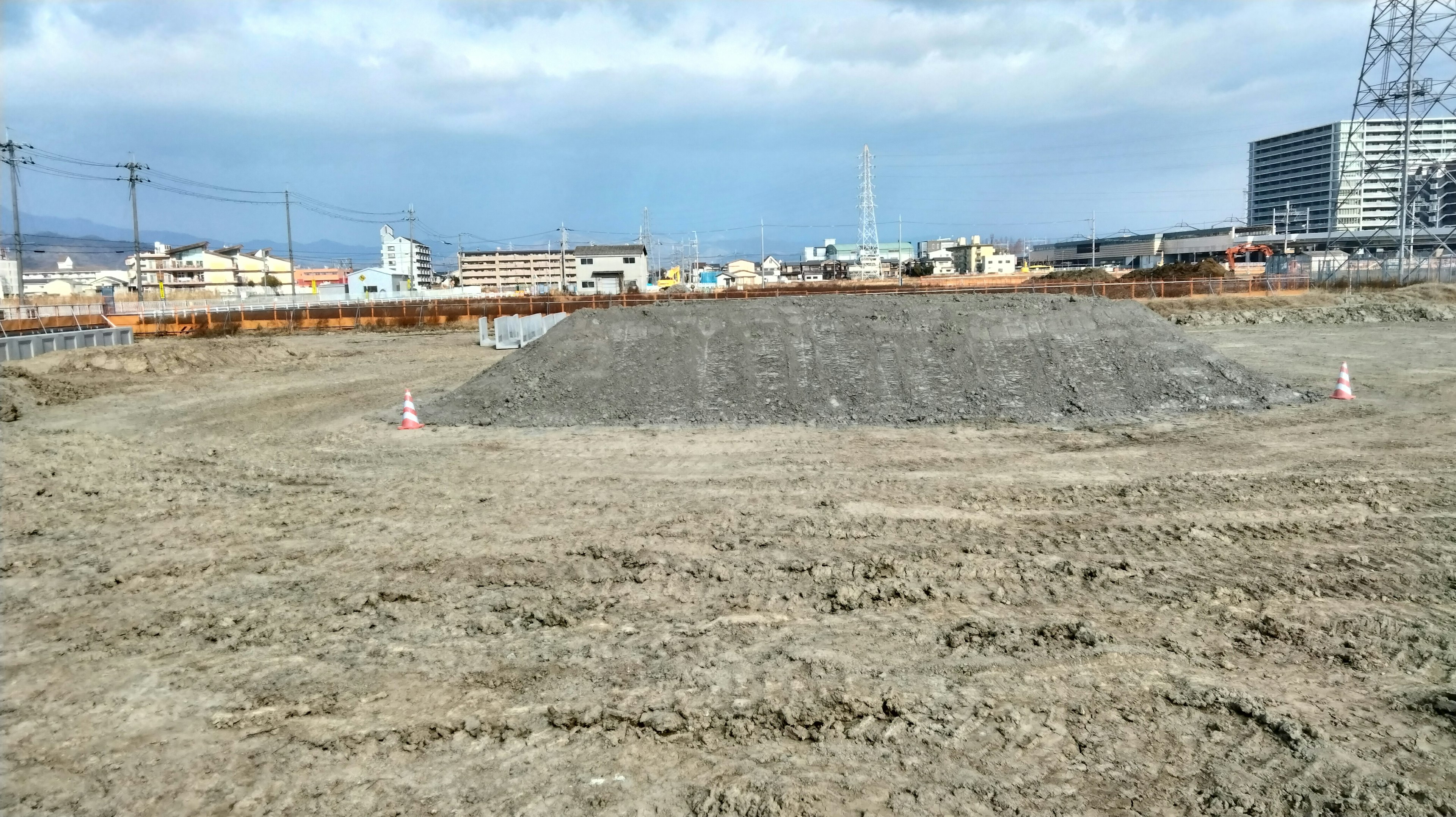 Construction site with a mound of dirt and blue sky