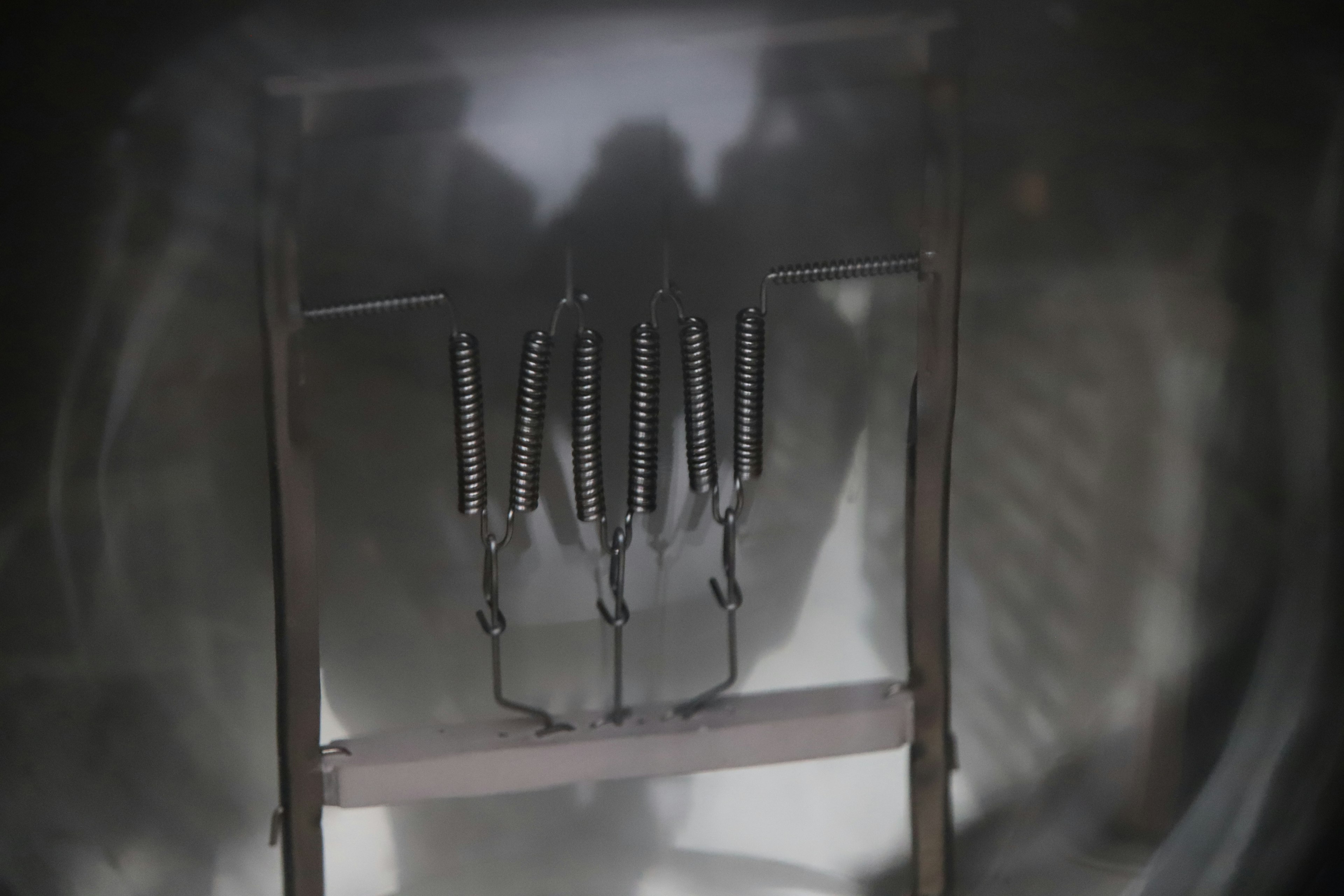 Image of metal springs arranged inside a machine