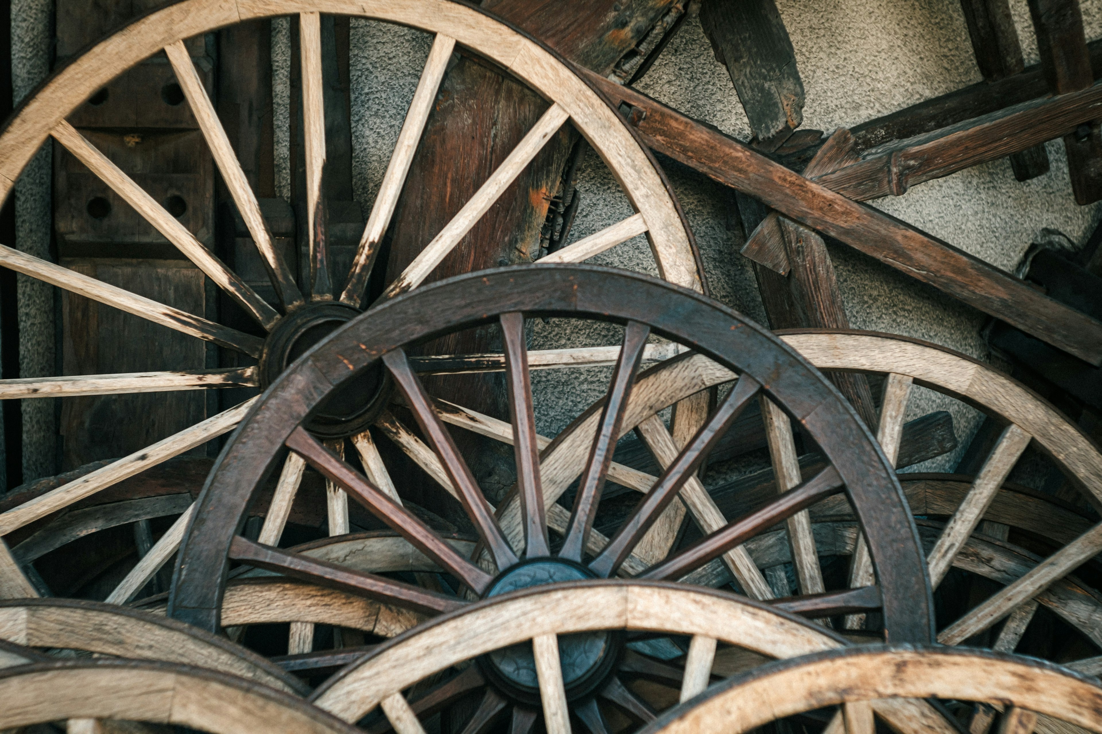 Stacked vintage wheels with a rustic wooden texture