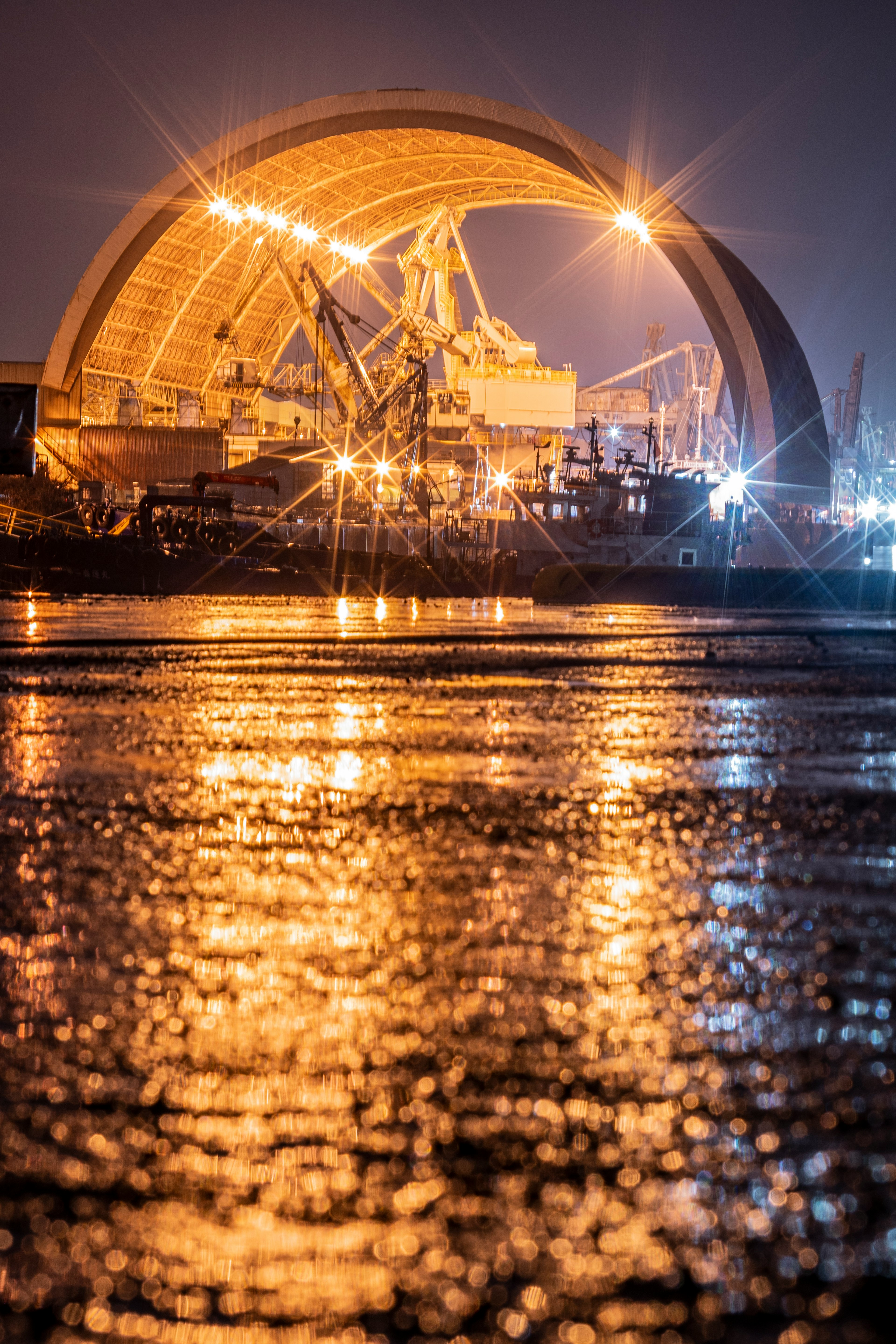 Large illuminated structure at a port during the night