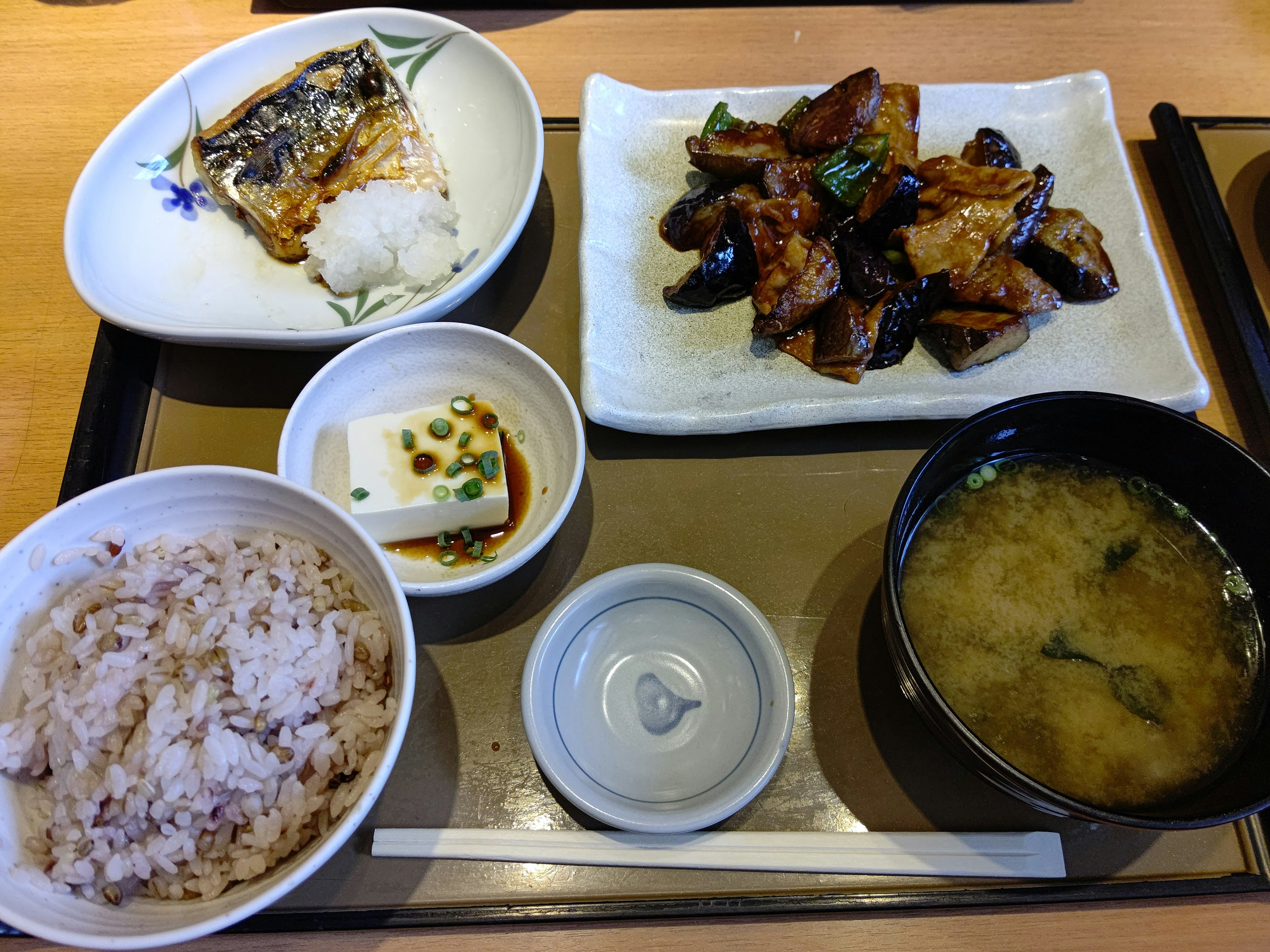 Japanese set meal featuring grilled fish rice miso soup and side dishes