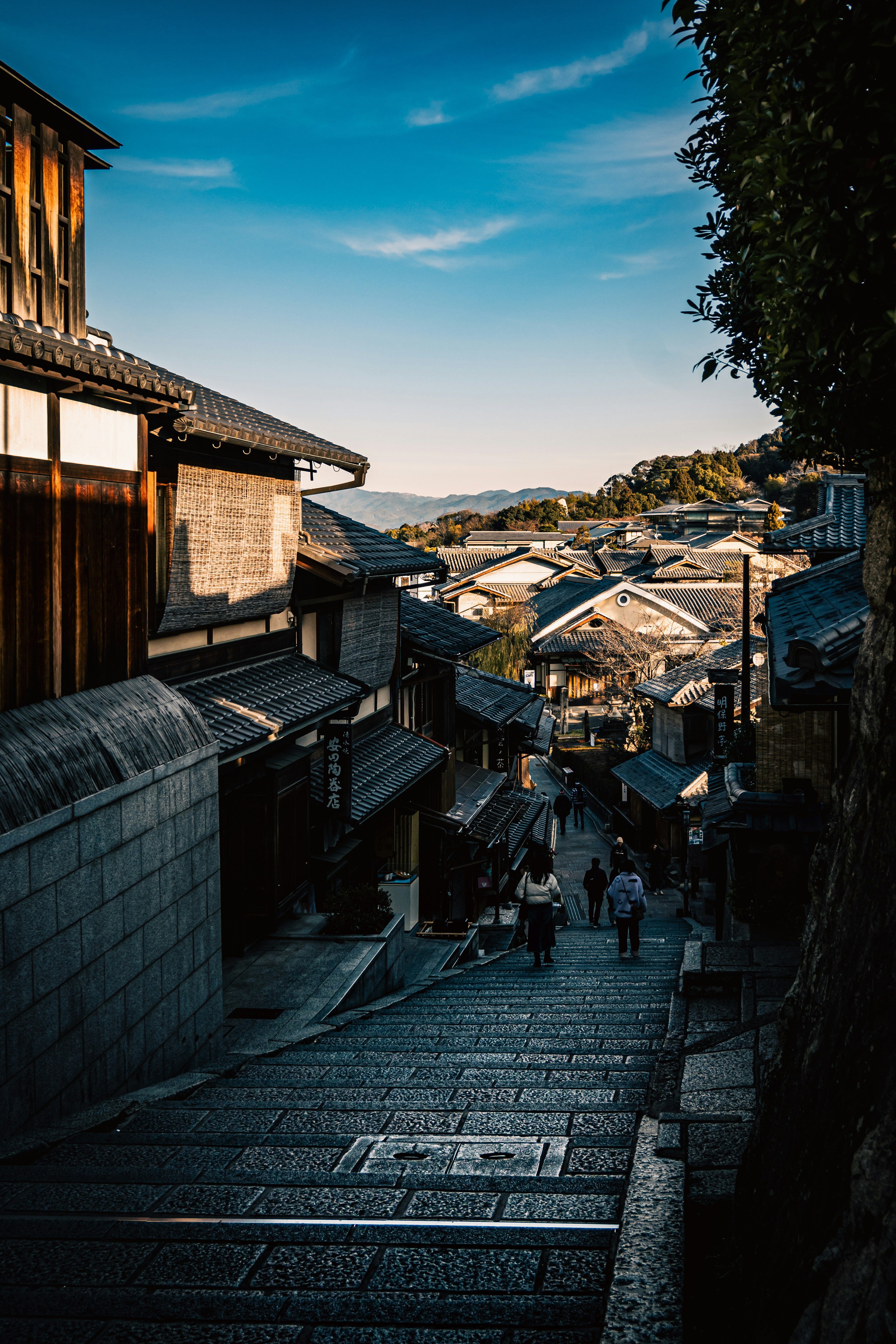 Stone steps leading down through traditional buildings under a blue sky