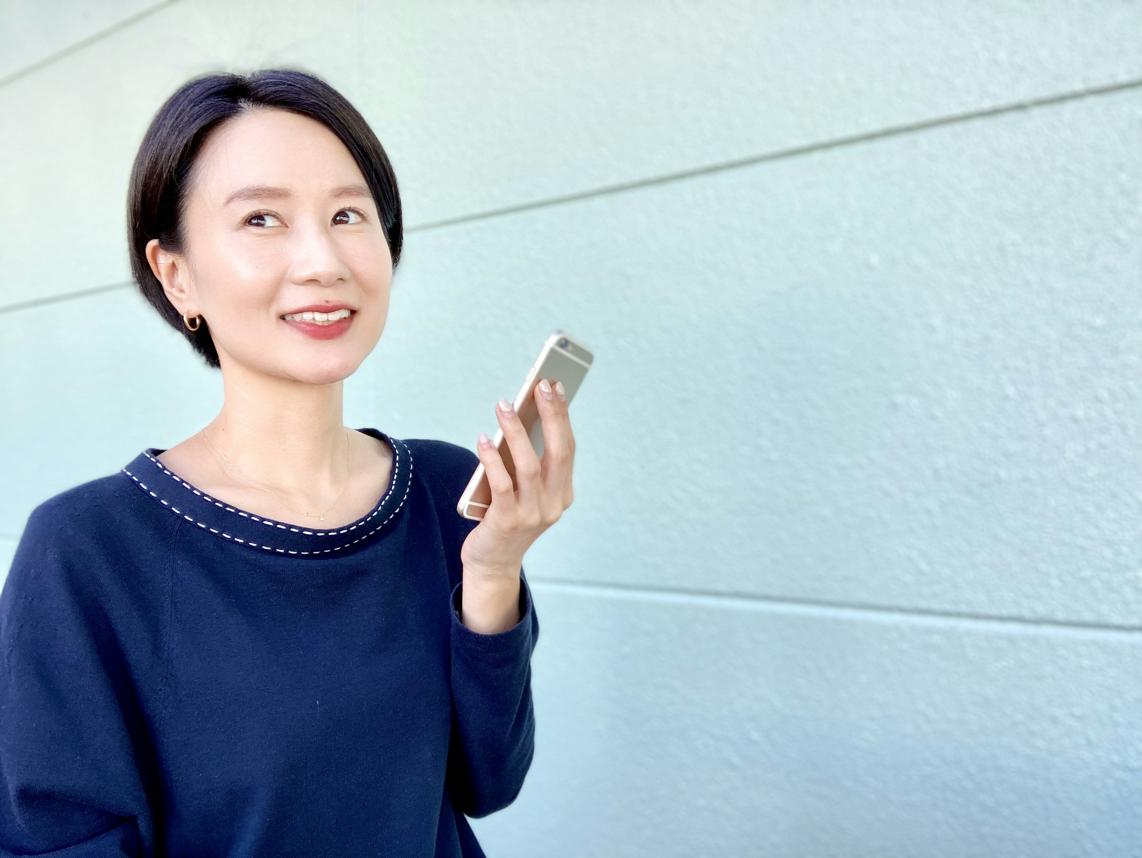 Portrait of a woman speaking into a smartphone