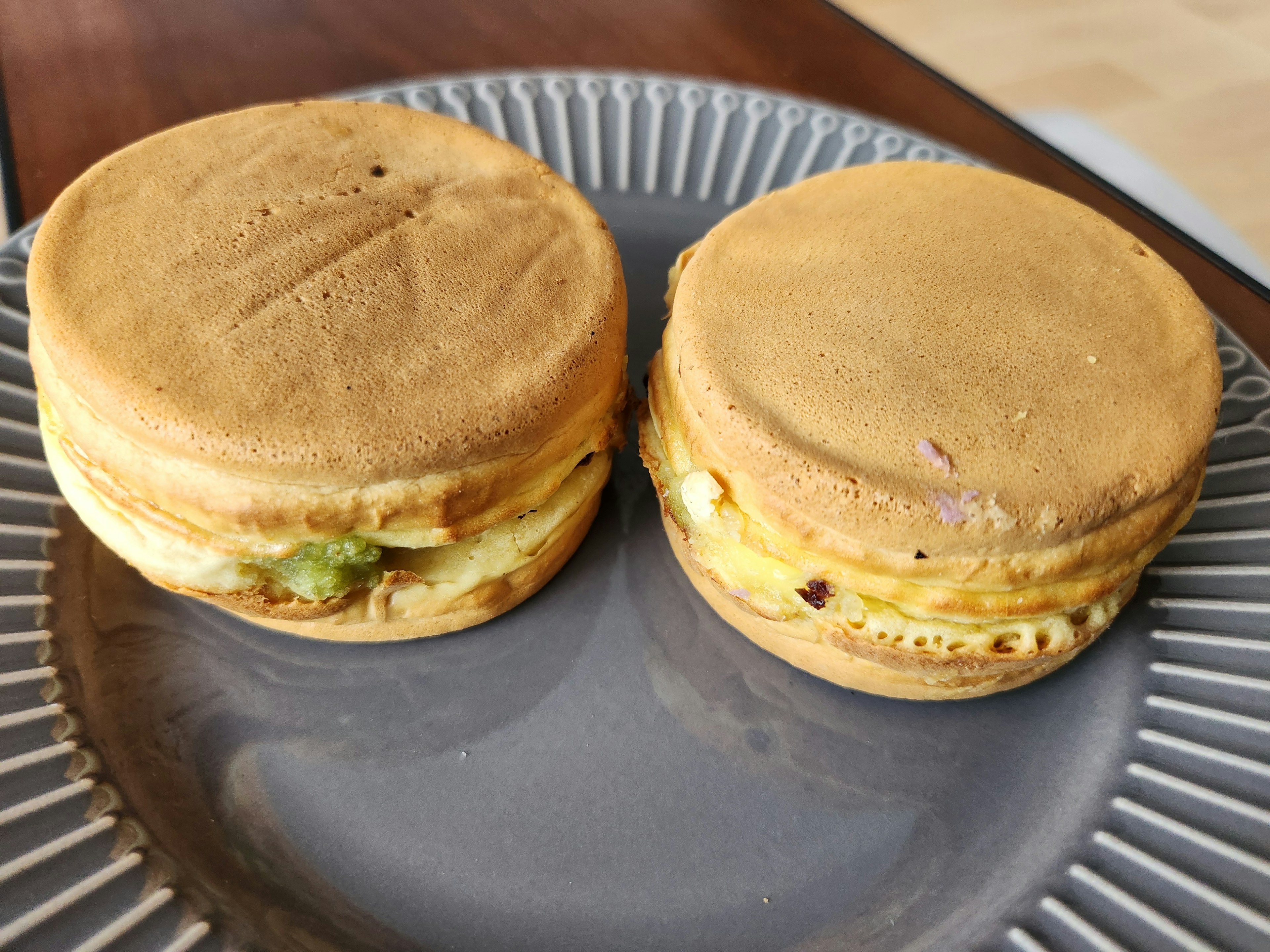 Two round pancakes stacked on a gray plate