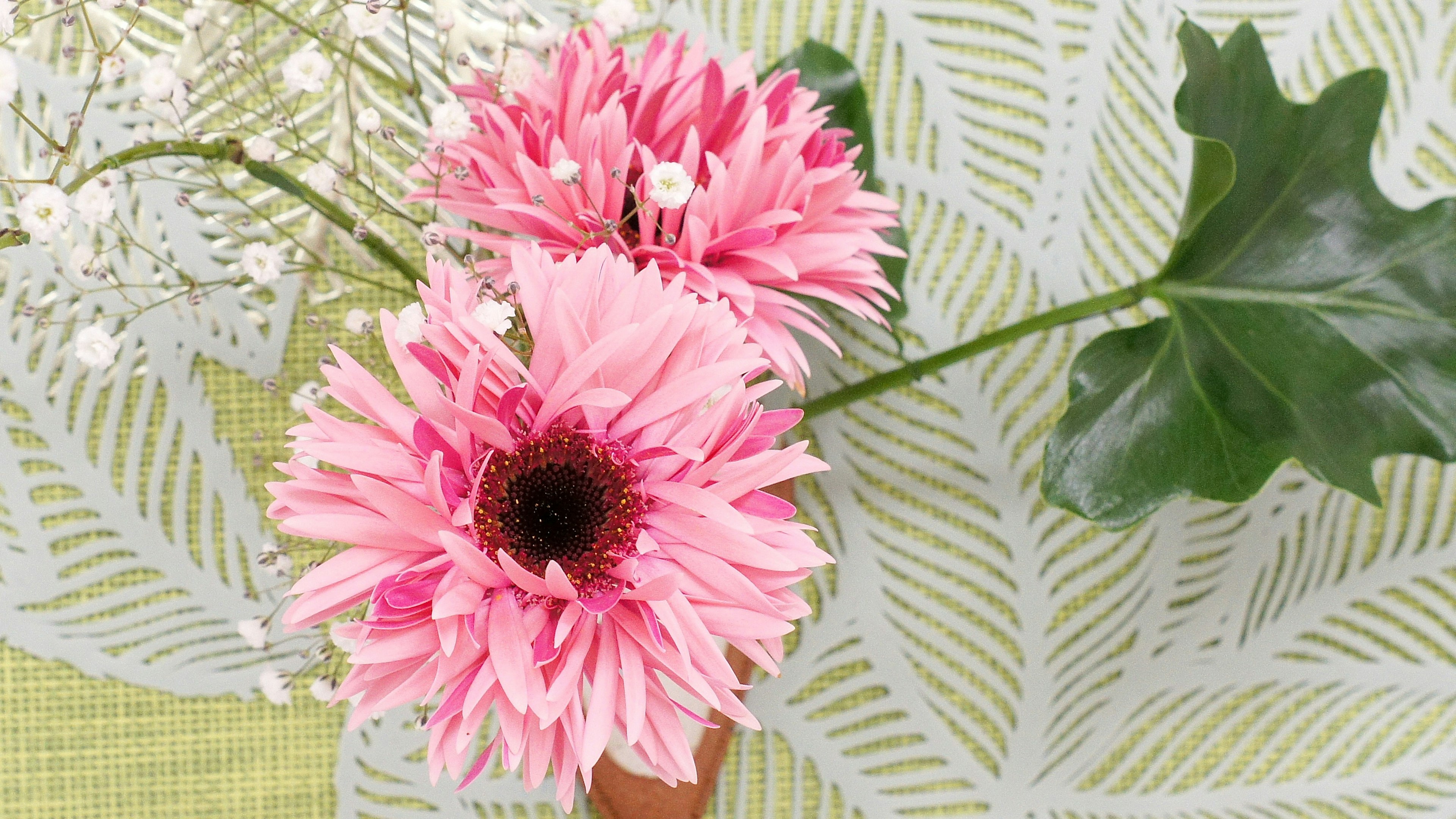 Beautiful arrangement with pink flowers and green leaves