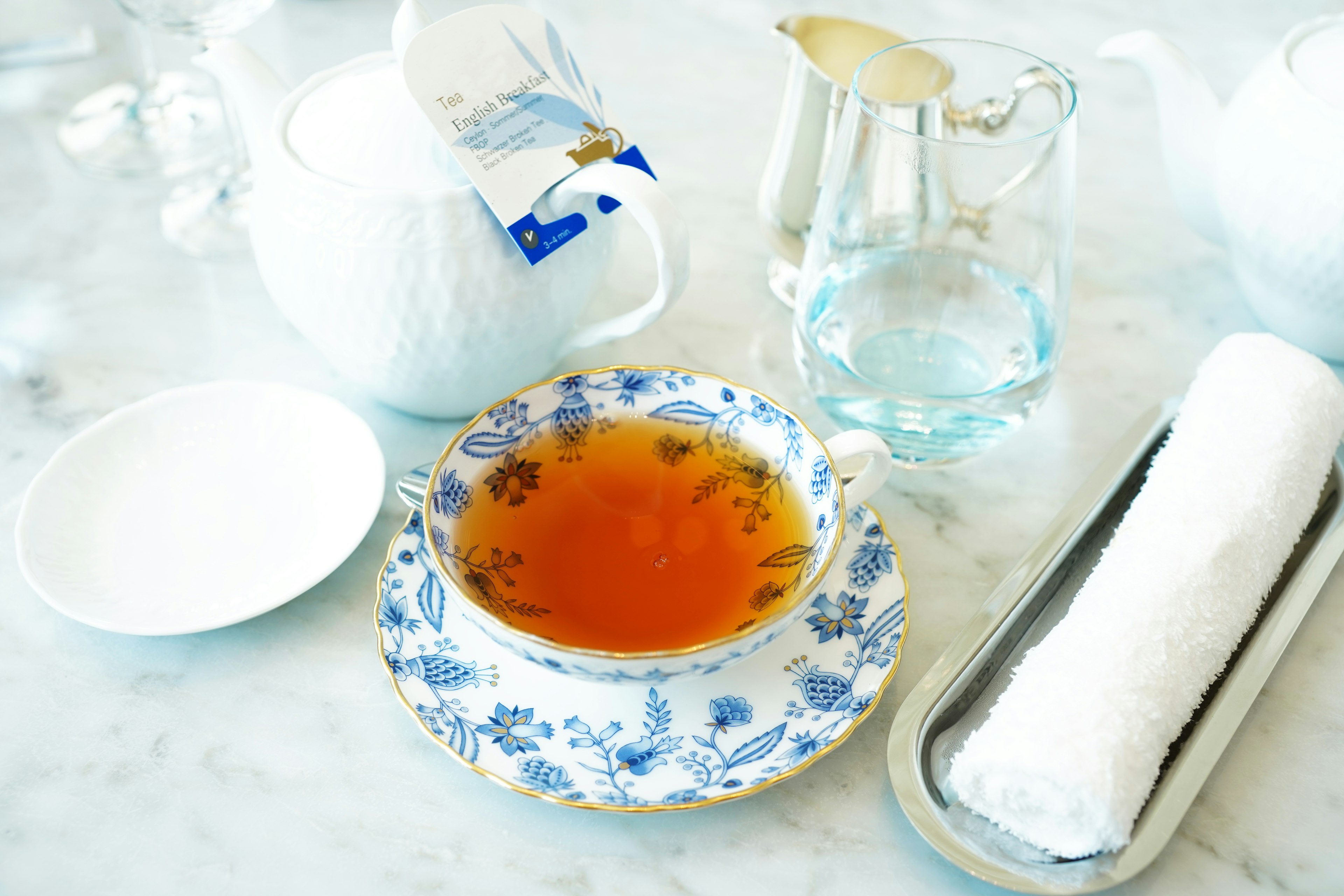 Service de table avec une tasse de thé à fleurs bleues