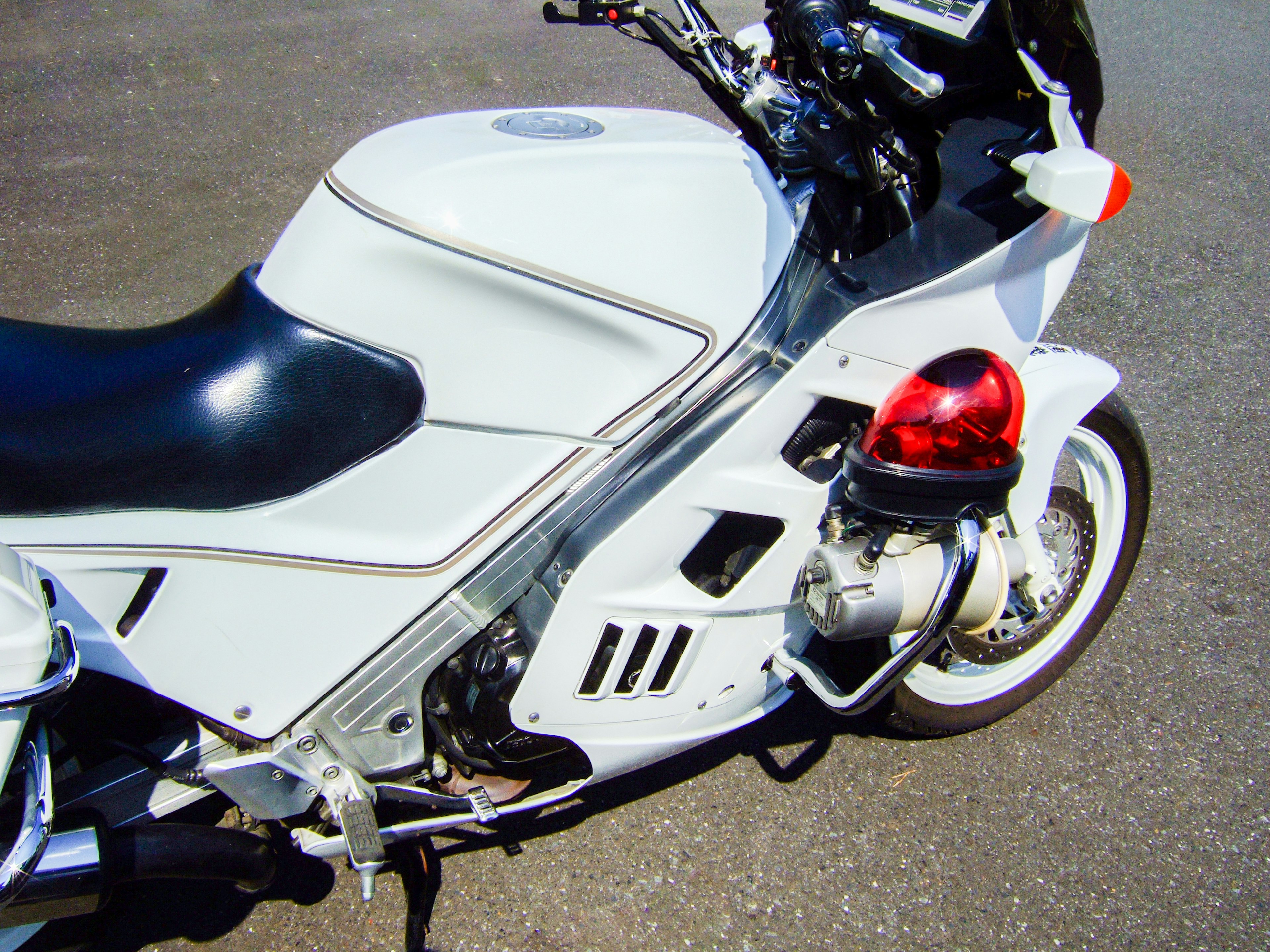 Close-up of a white and black motorcycle side