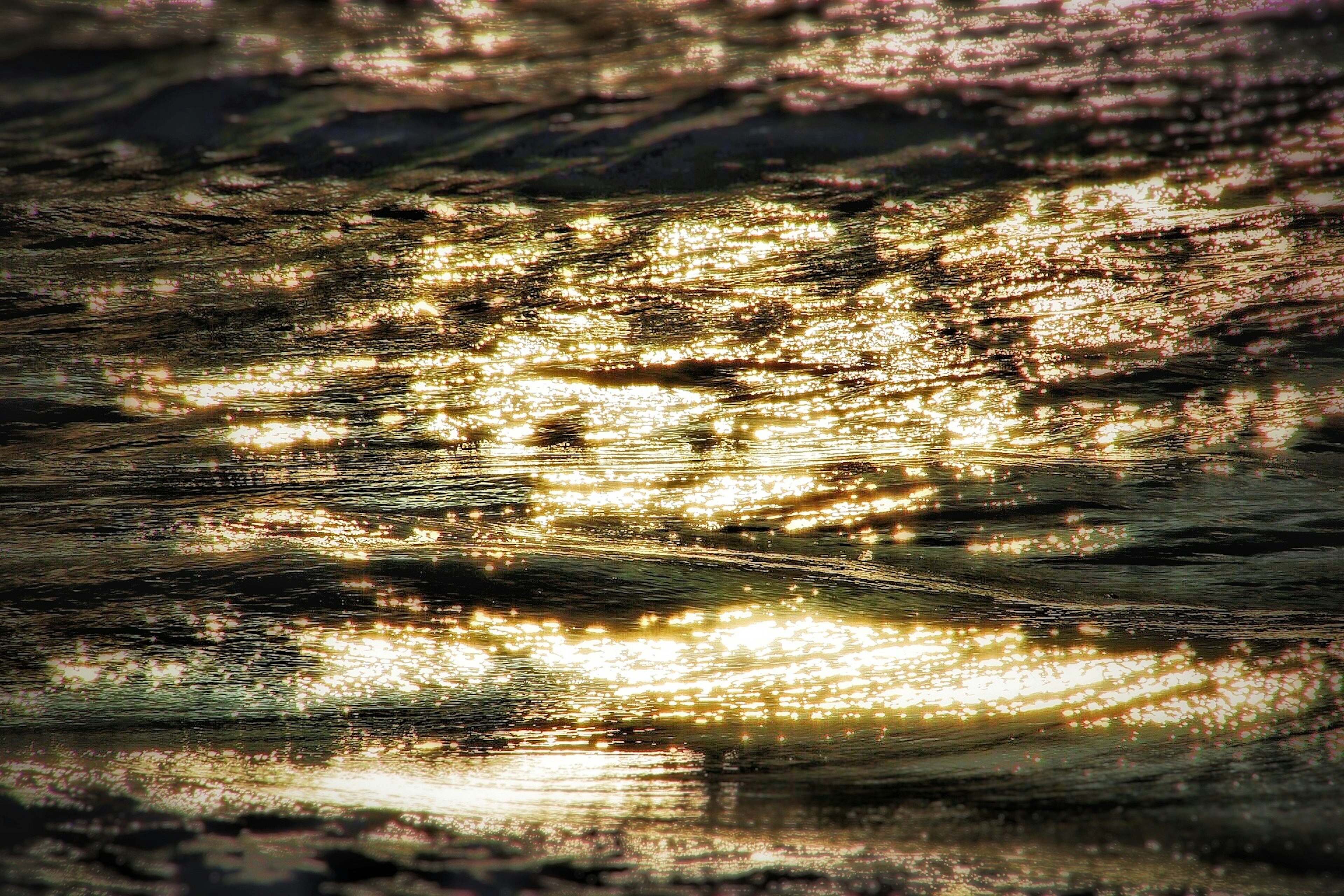 Patterns and colors of light reflecting on water surface