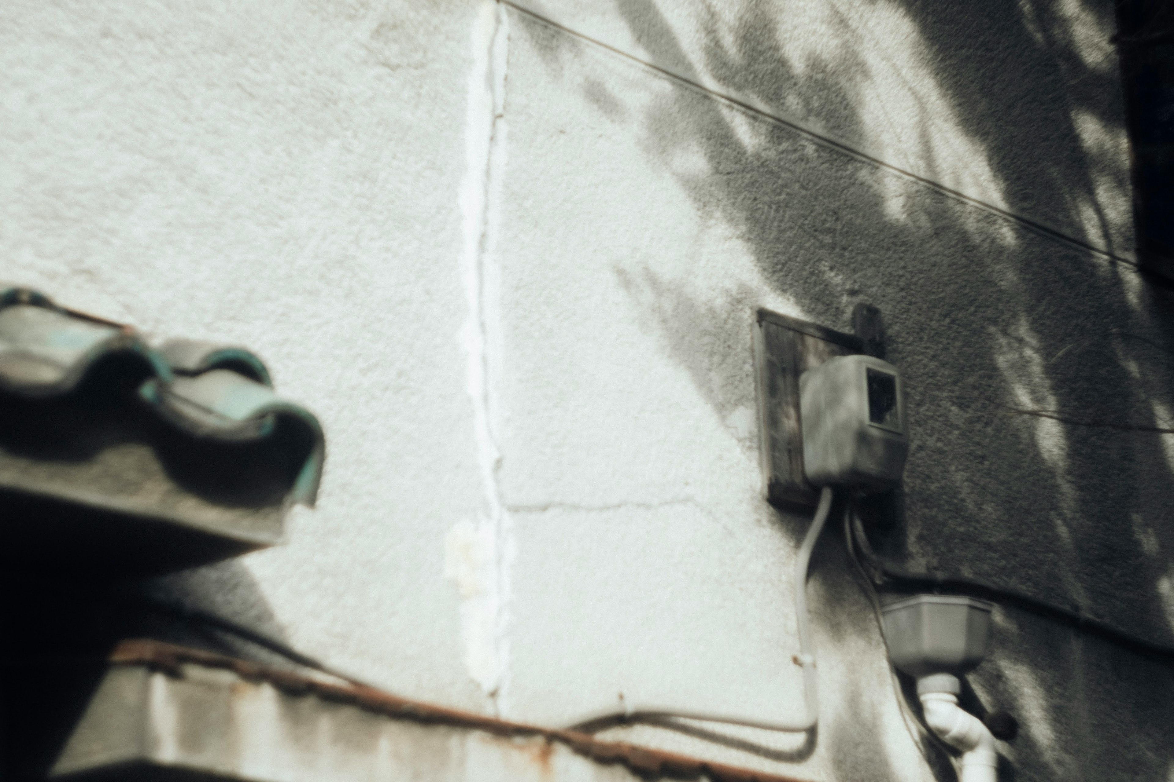 Image showing part of a wall with shadows an electric meter mounted