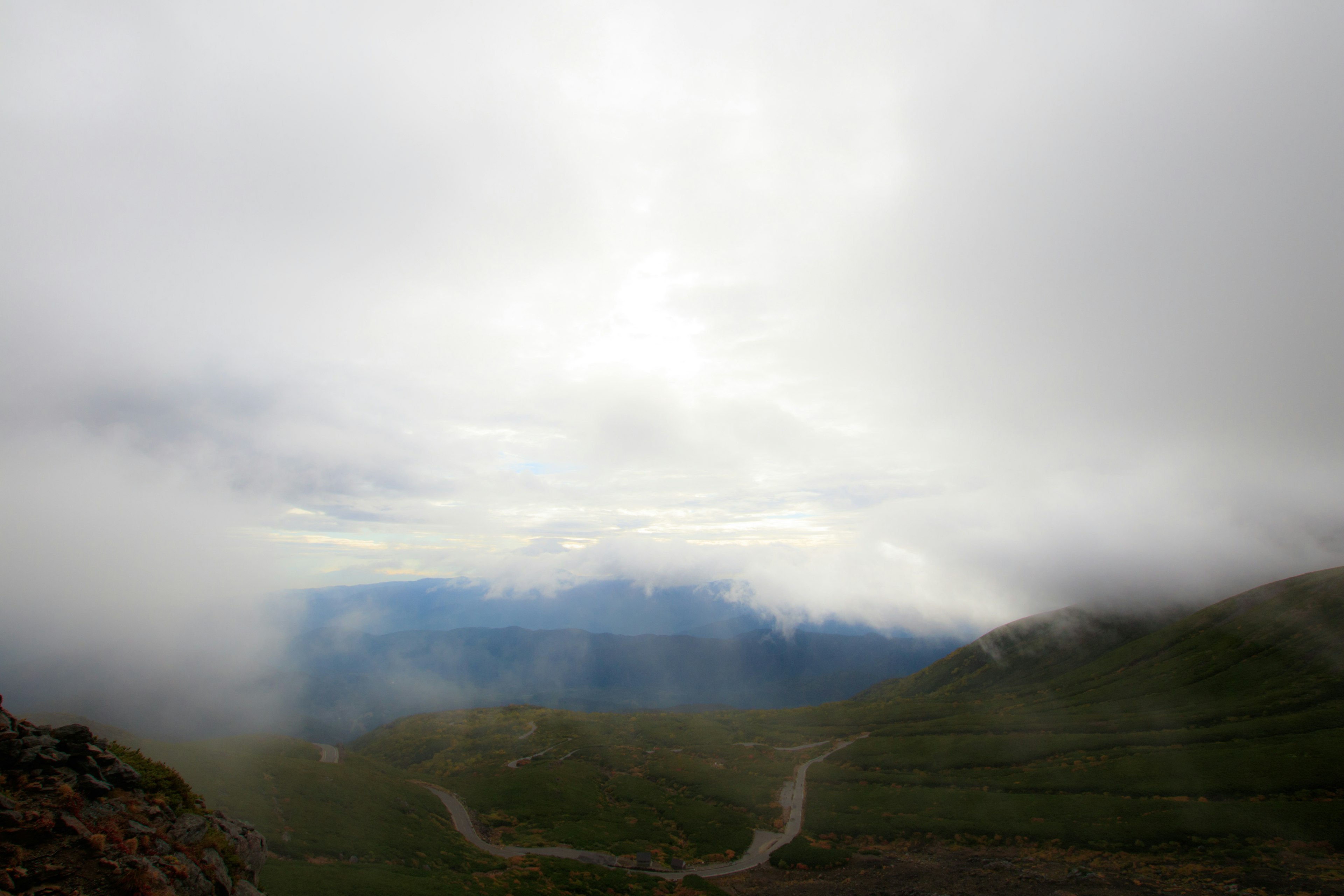 Foggy mountain landscape with distant blue mountains