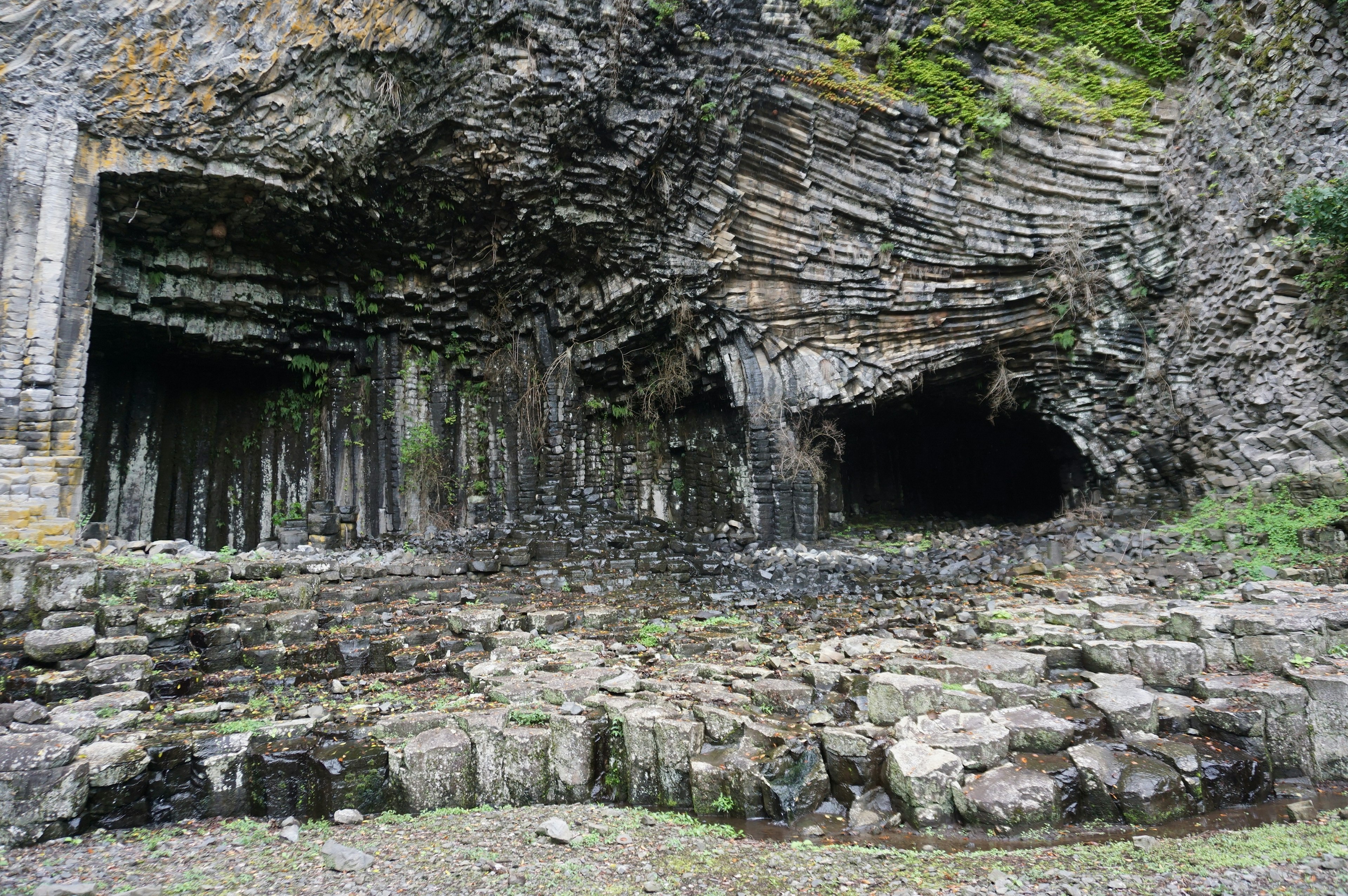 Landscape featuring layered rocks and cave entrances