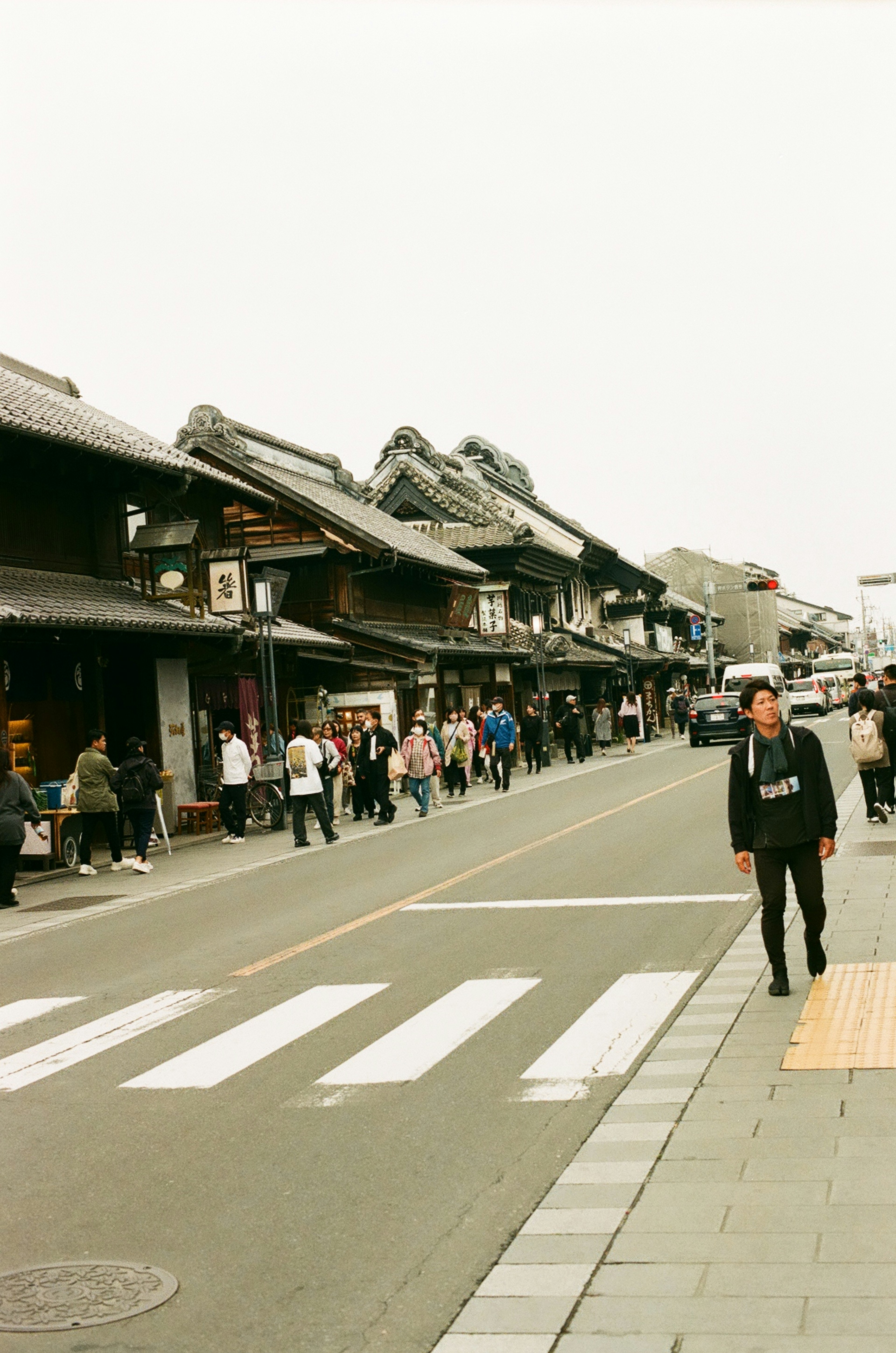 Bustling street scene with traditional Japanese architecture and pedestrians