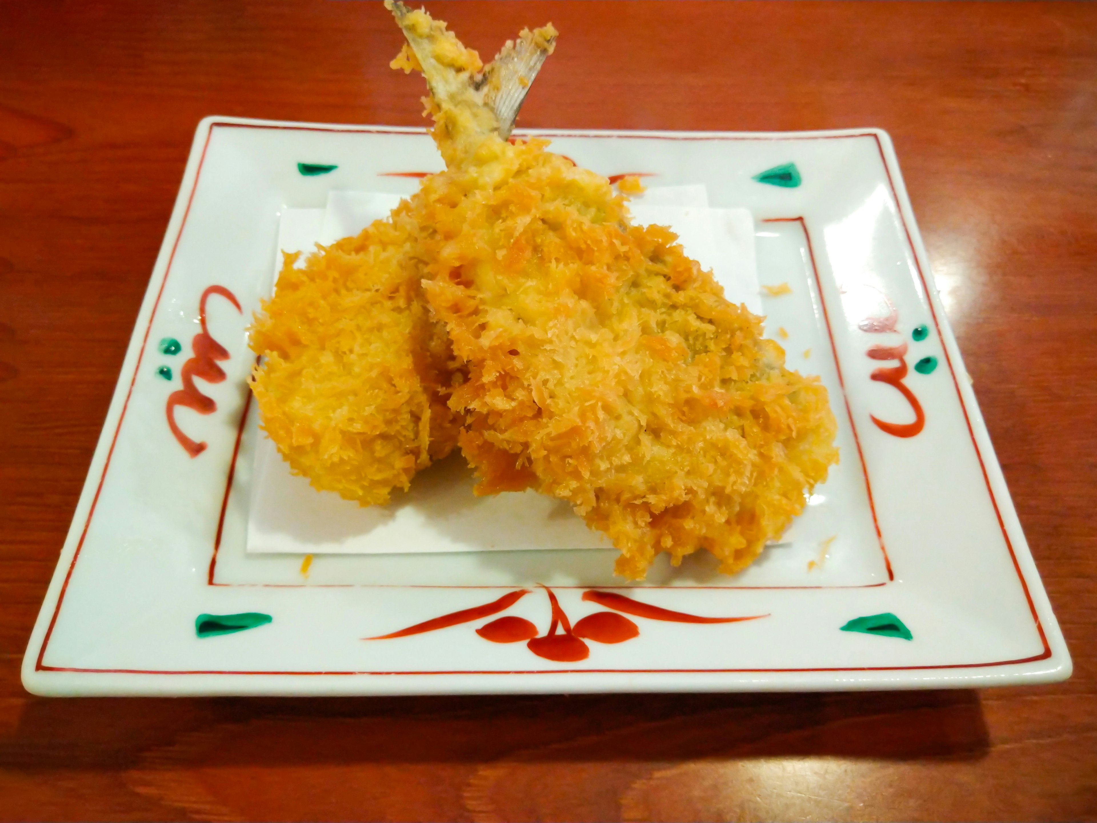 Crispy fried shrimp tempura served on a decorative plate