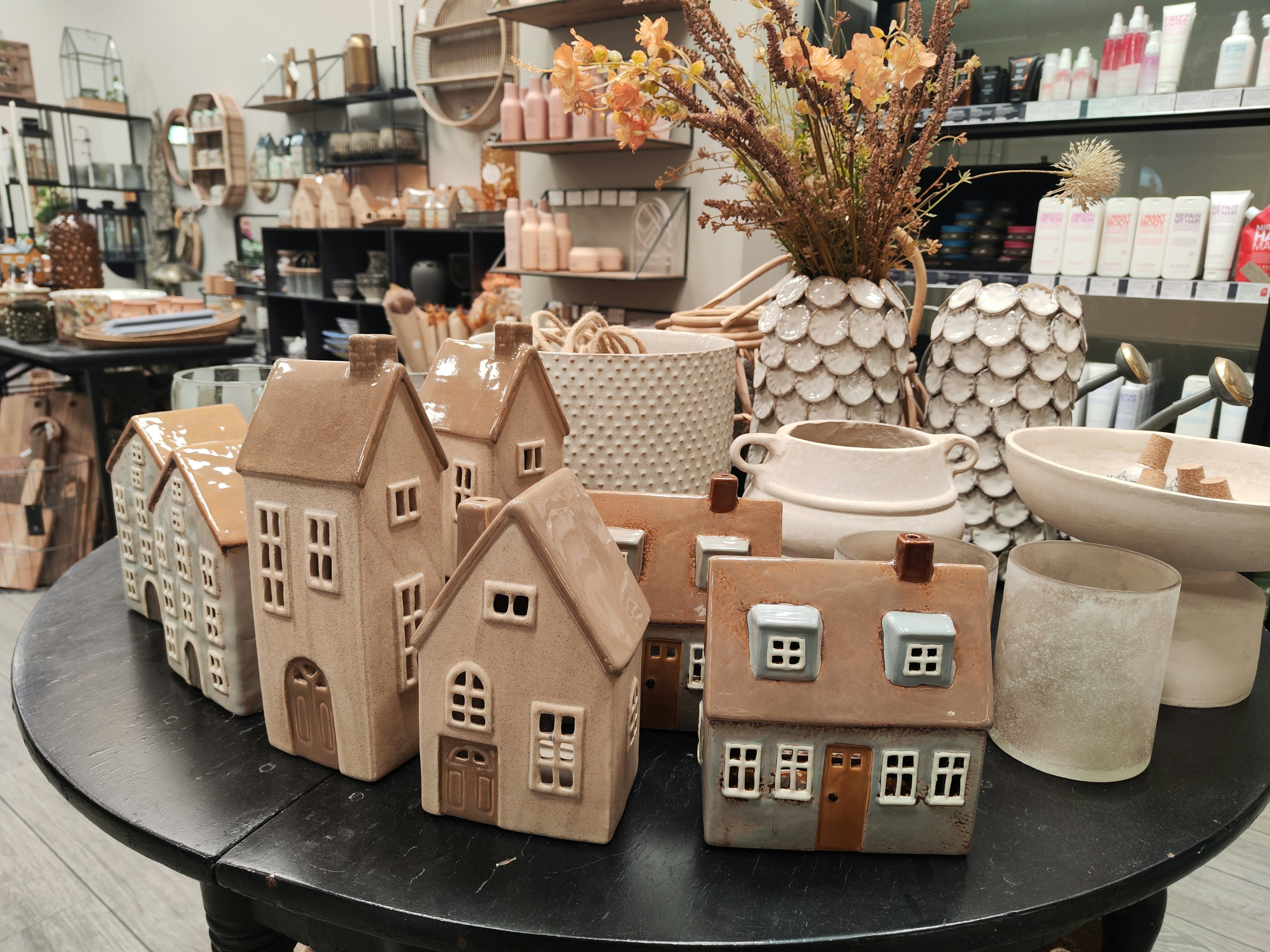 Decorative ceramic house-shaped items arranged on a table