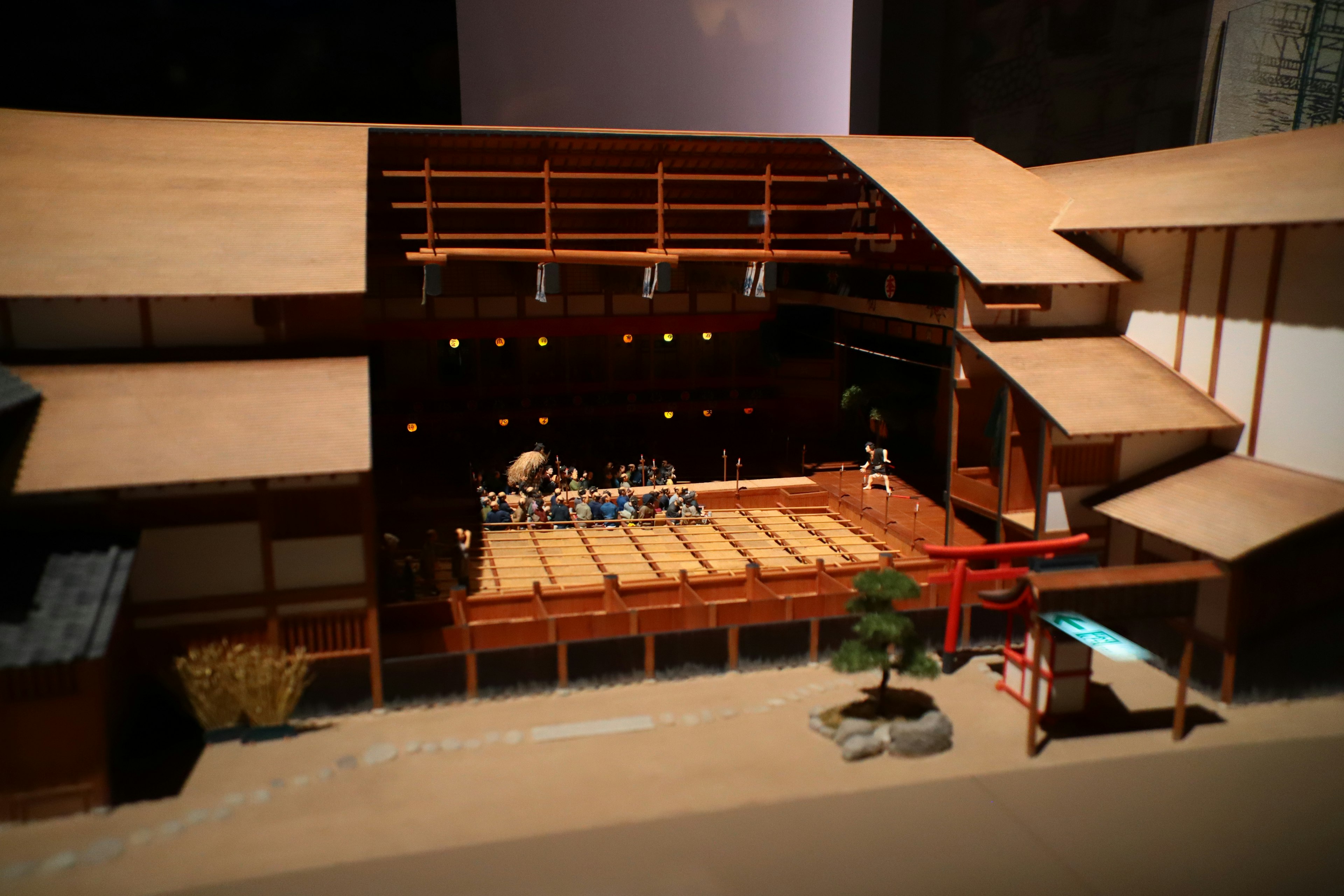 Miniature model of a traditional Japanese stage featuring wooden architecture and performance area