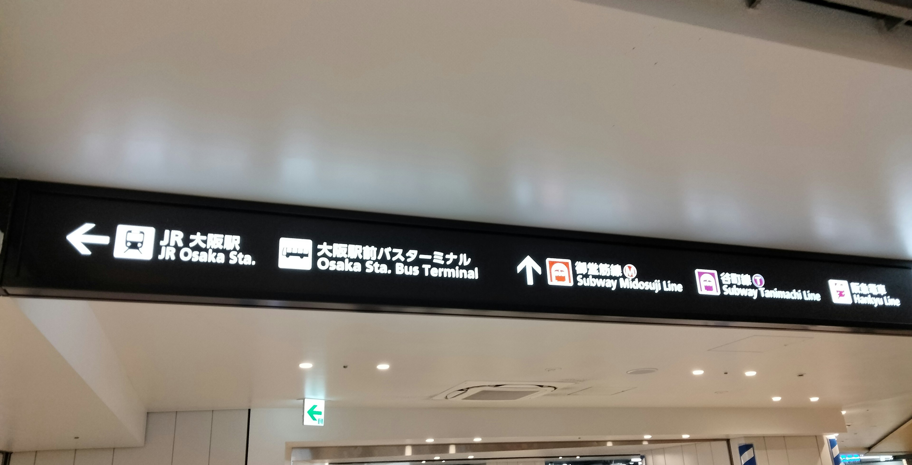 Airport signage displaying directions to various facilities