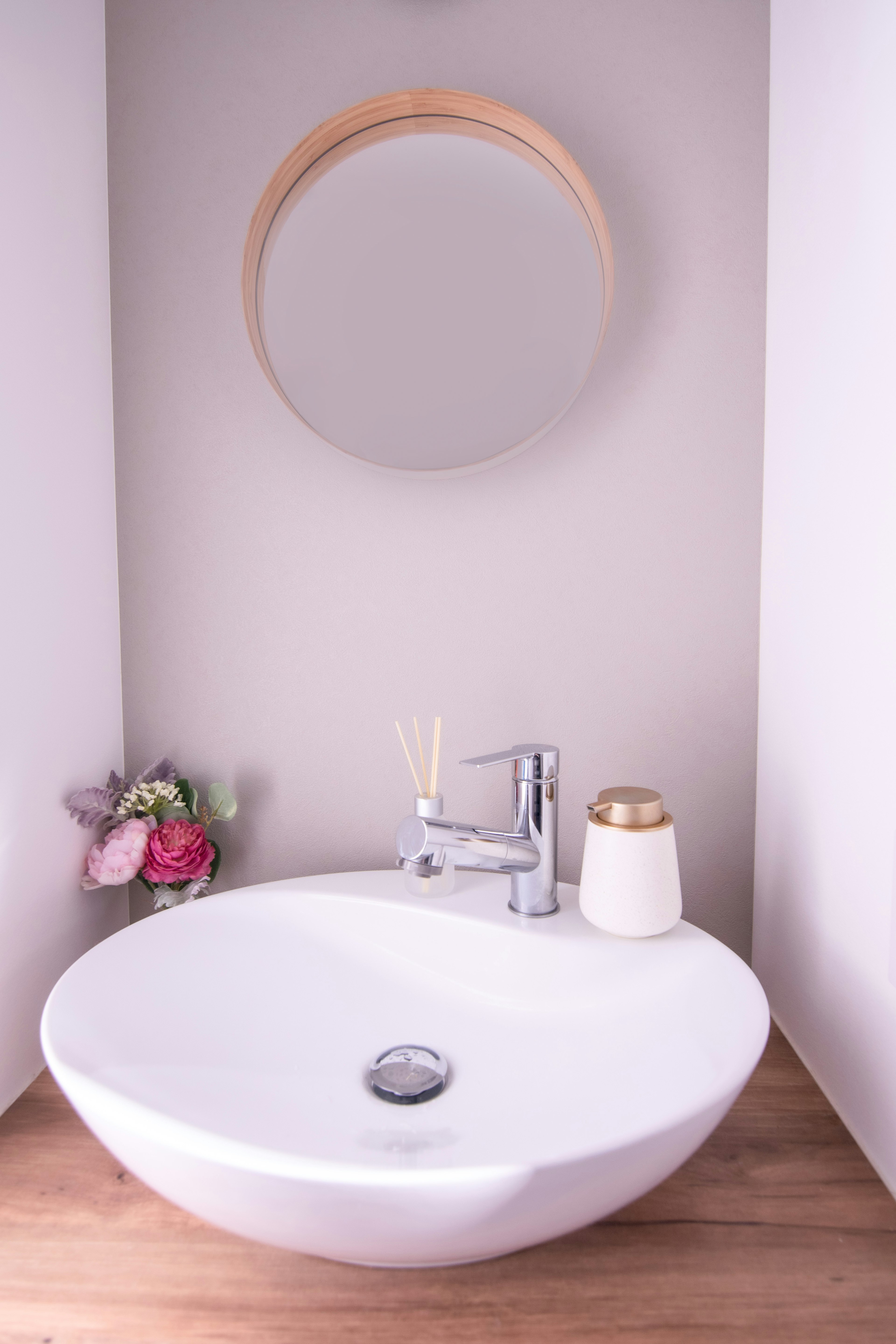 Modern bathroom sink with round mirror and elegant decor