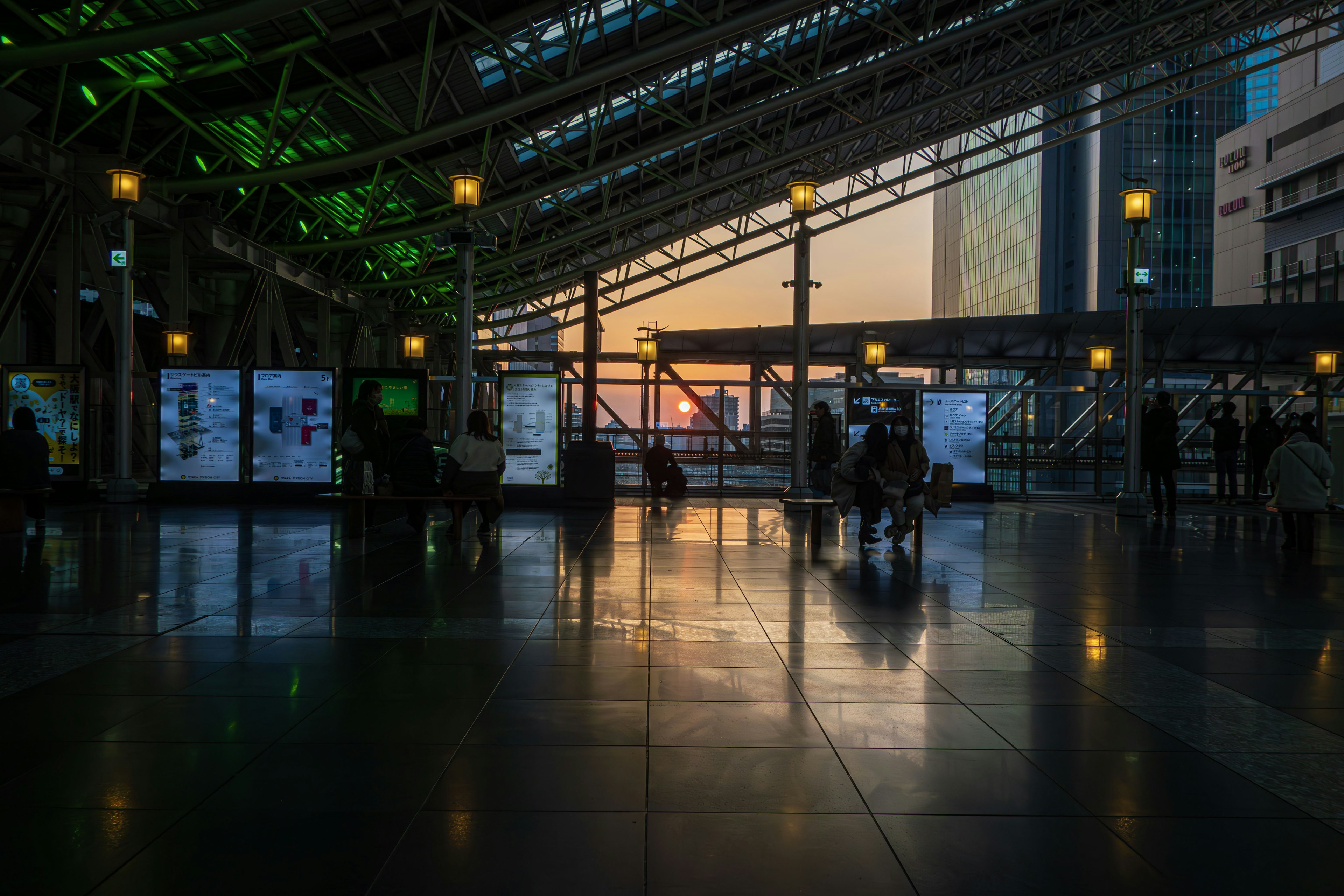 Spacious train station interior with sunset reflections modern design and green lighting