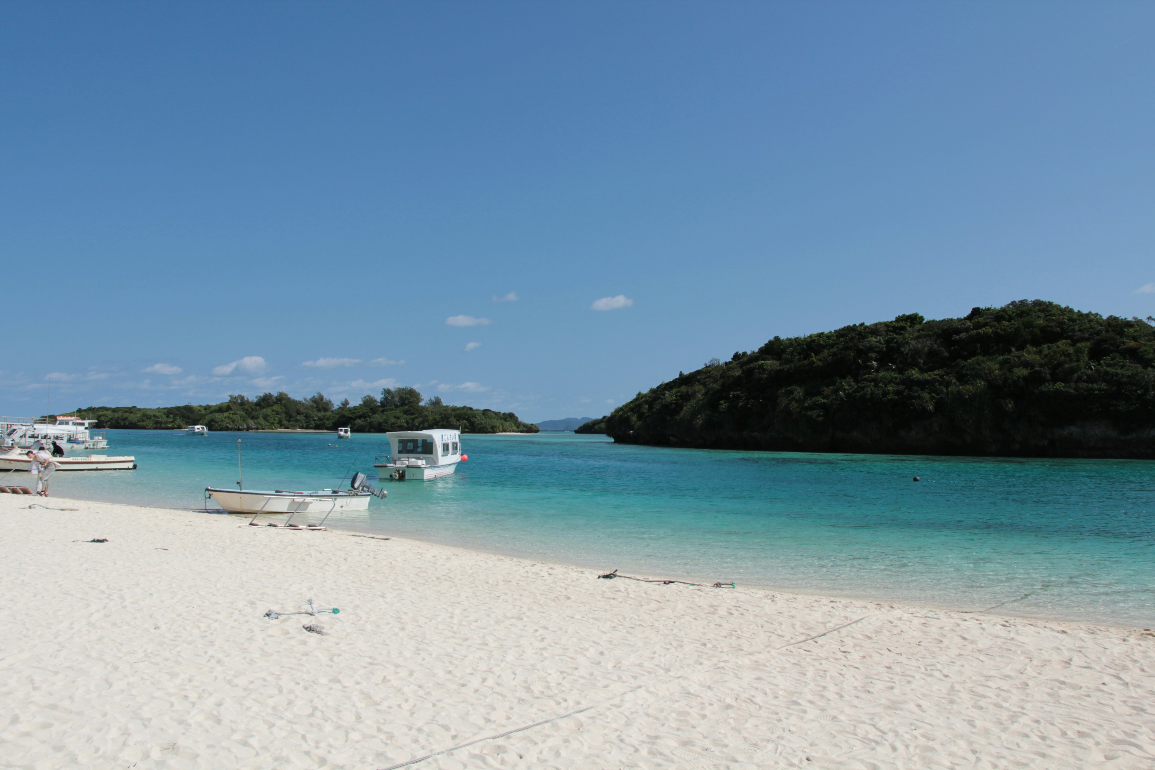 ทิวทัศน์ชายหาดที่สวยงามมีน้ำสีฟ้าและทรายขาว