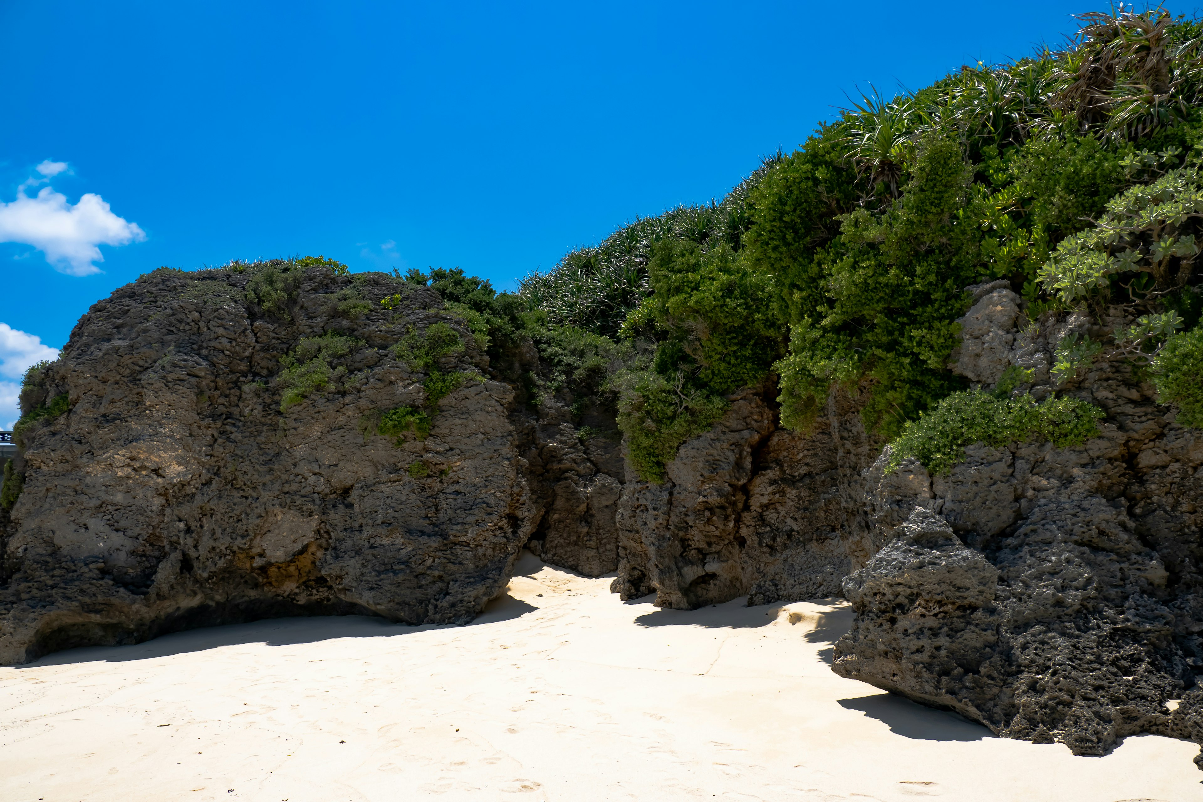 Scenic beach view with blue sky and white sand