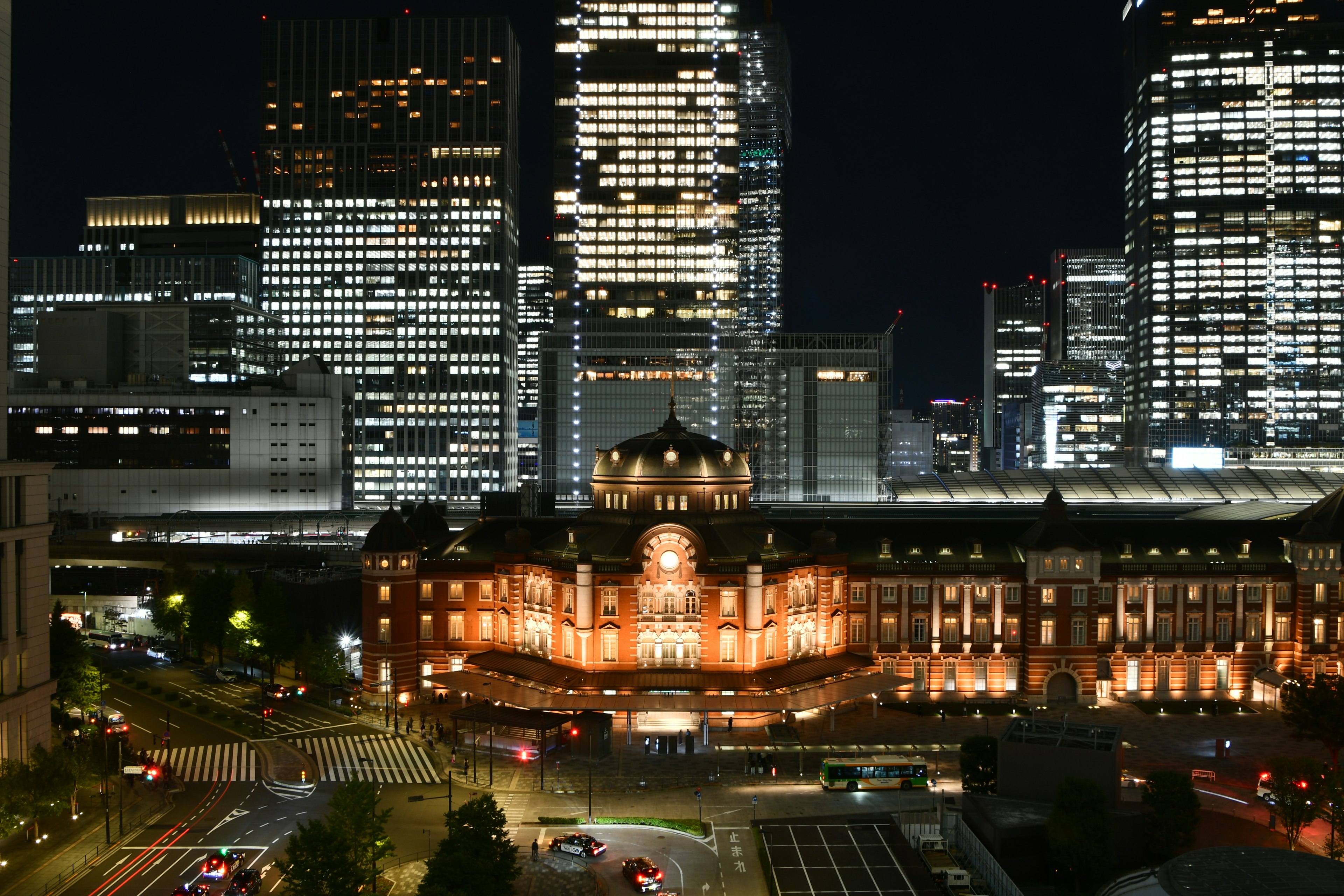 Tokyo Station at night with modern skyscrapers