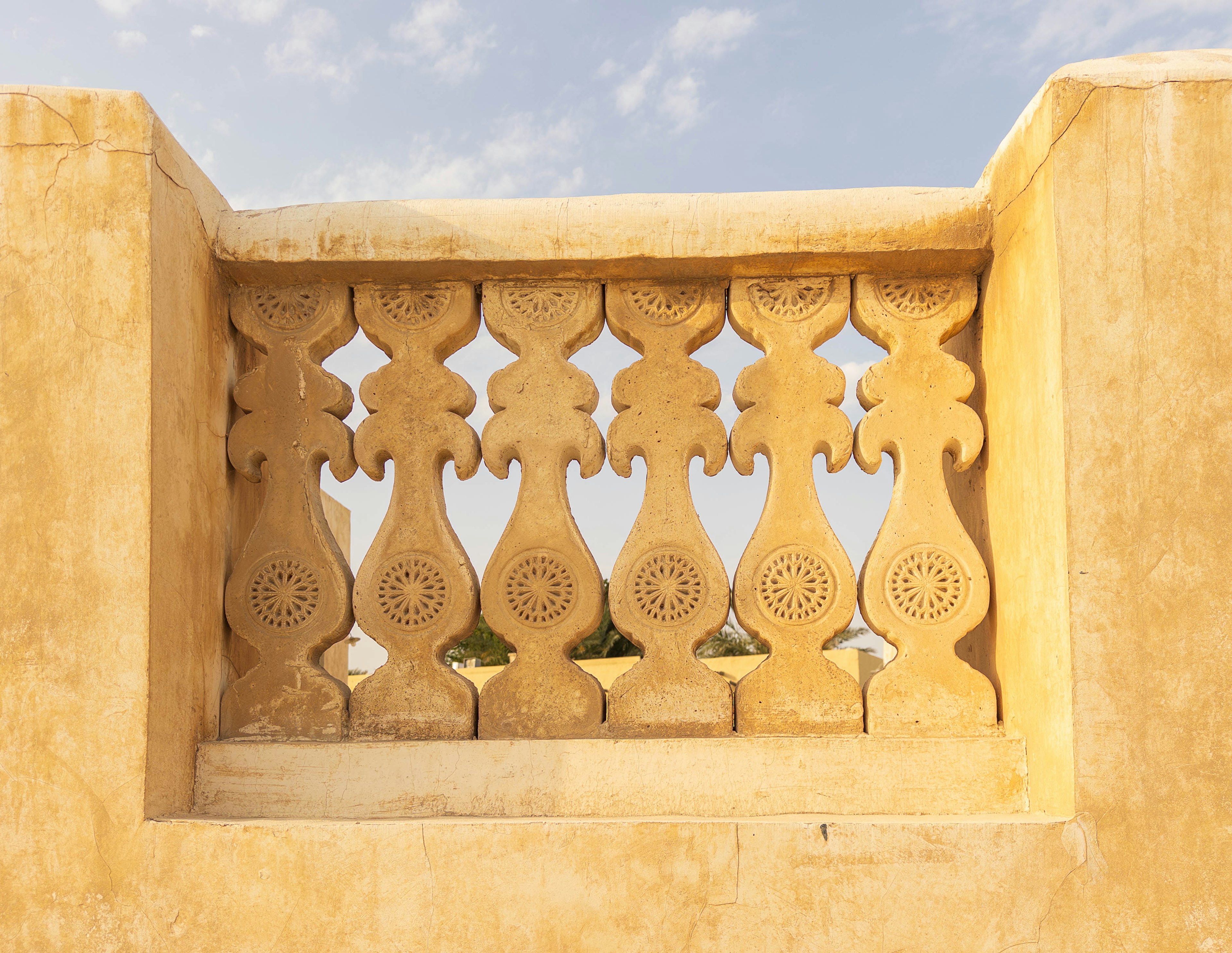 Decorative balcony wall section featuring beautiful patterned stone carvings