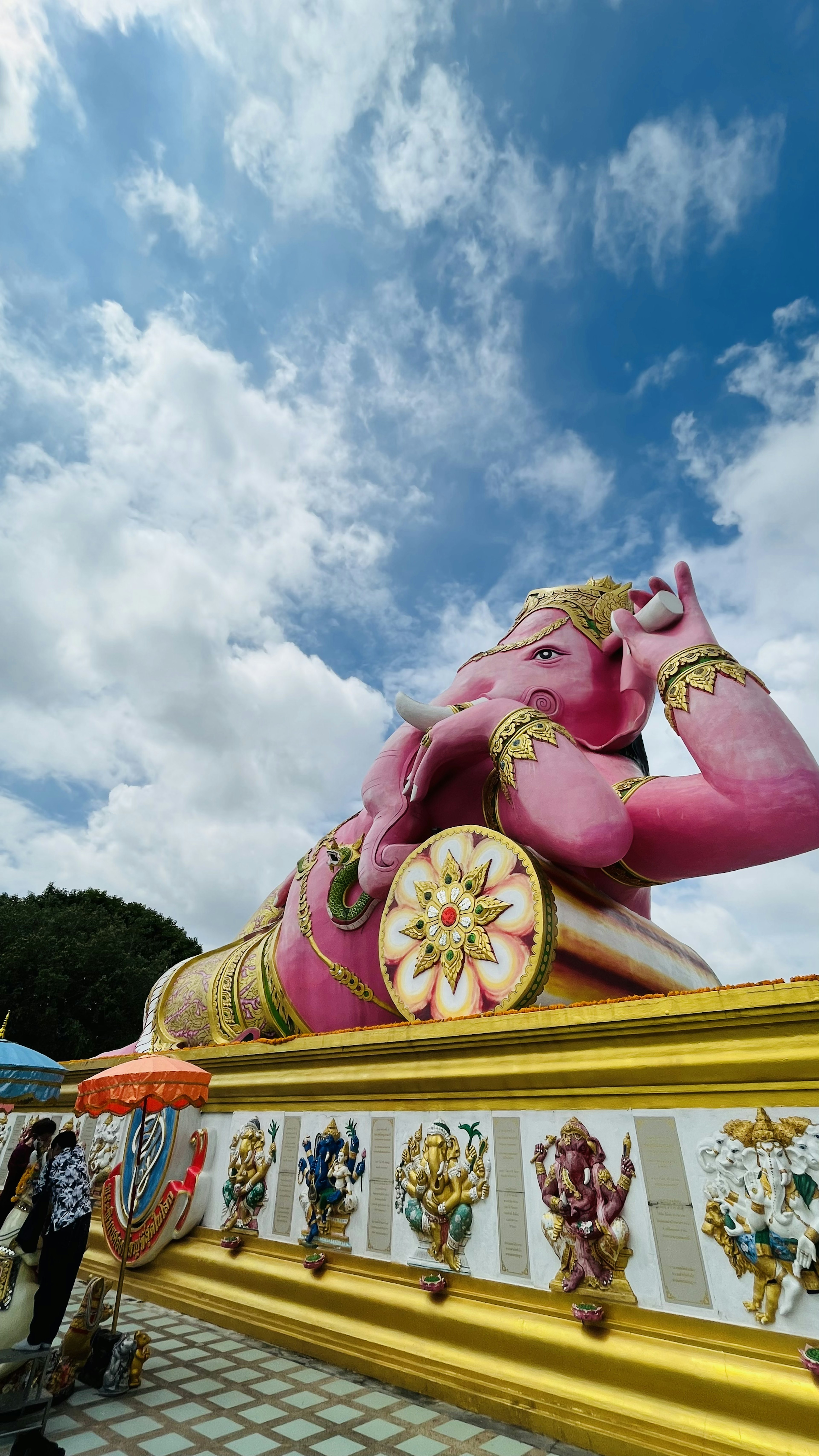 Grande statue de Bouddha couché rose sous un ciel bleu