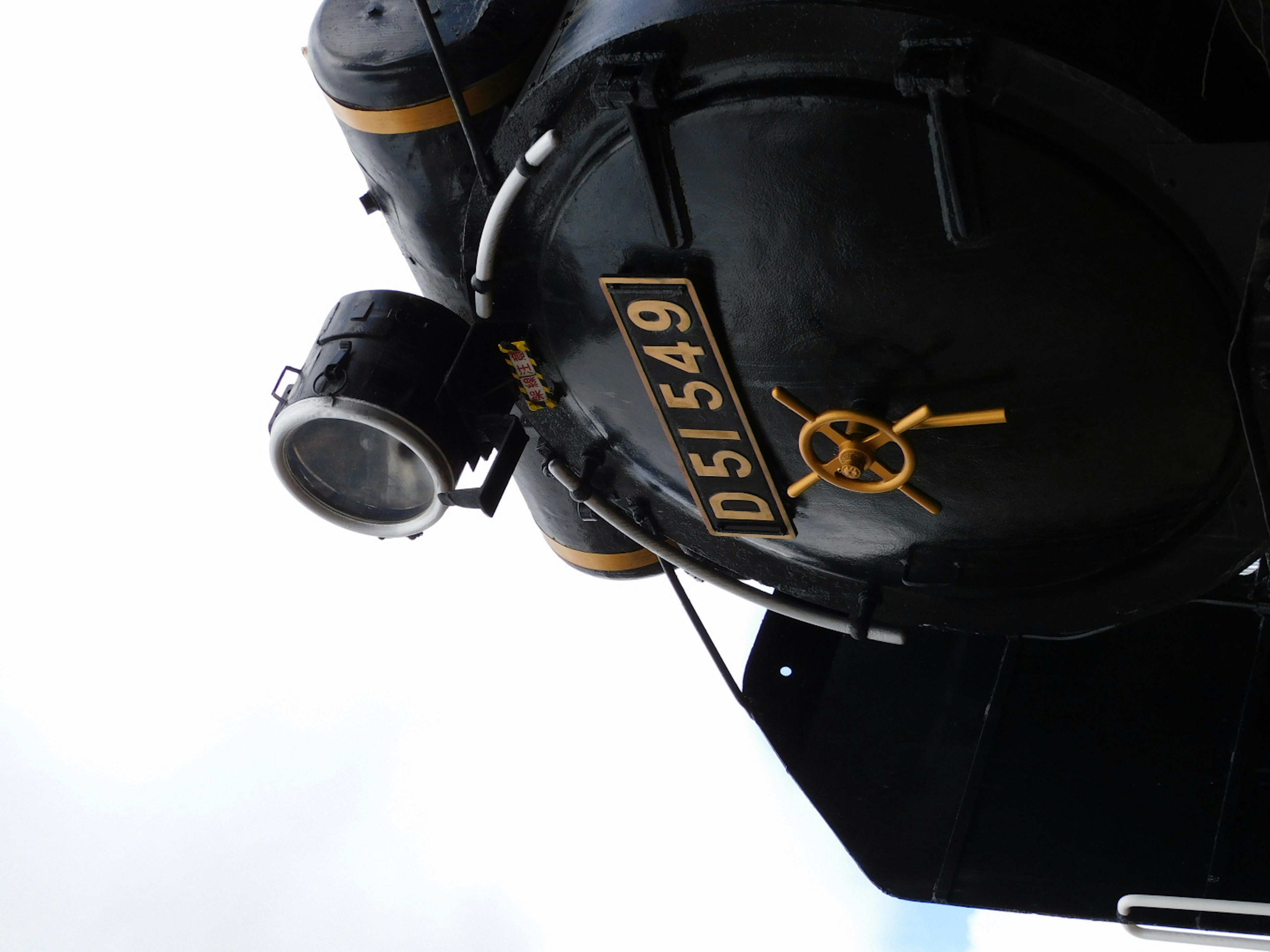 Side view of a black steam locomotive featuring the D5149 number plate and a headlight