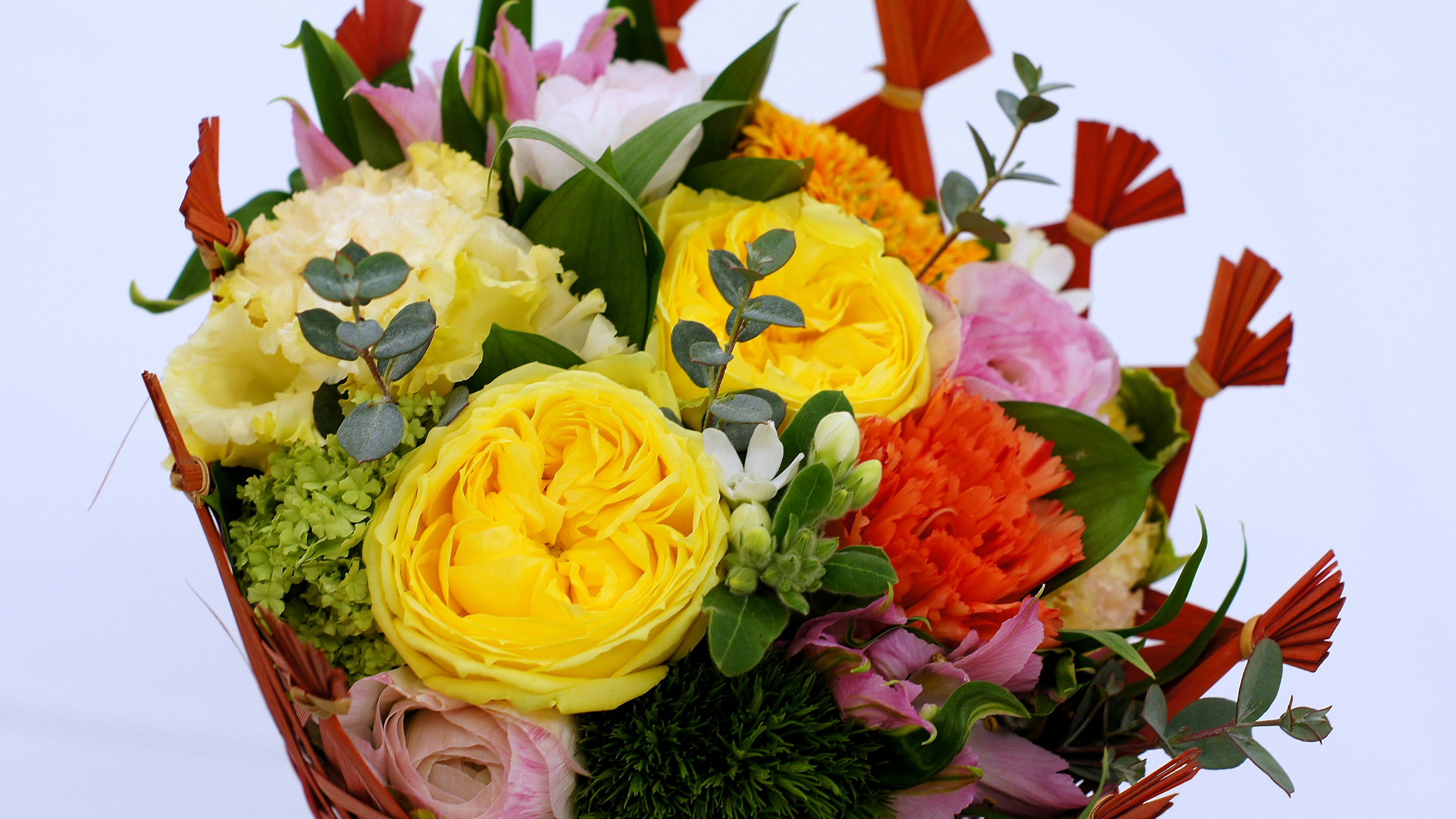 Colorful bouquet featuring yellow roses and green leaves