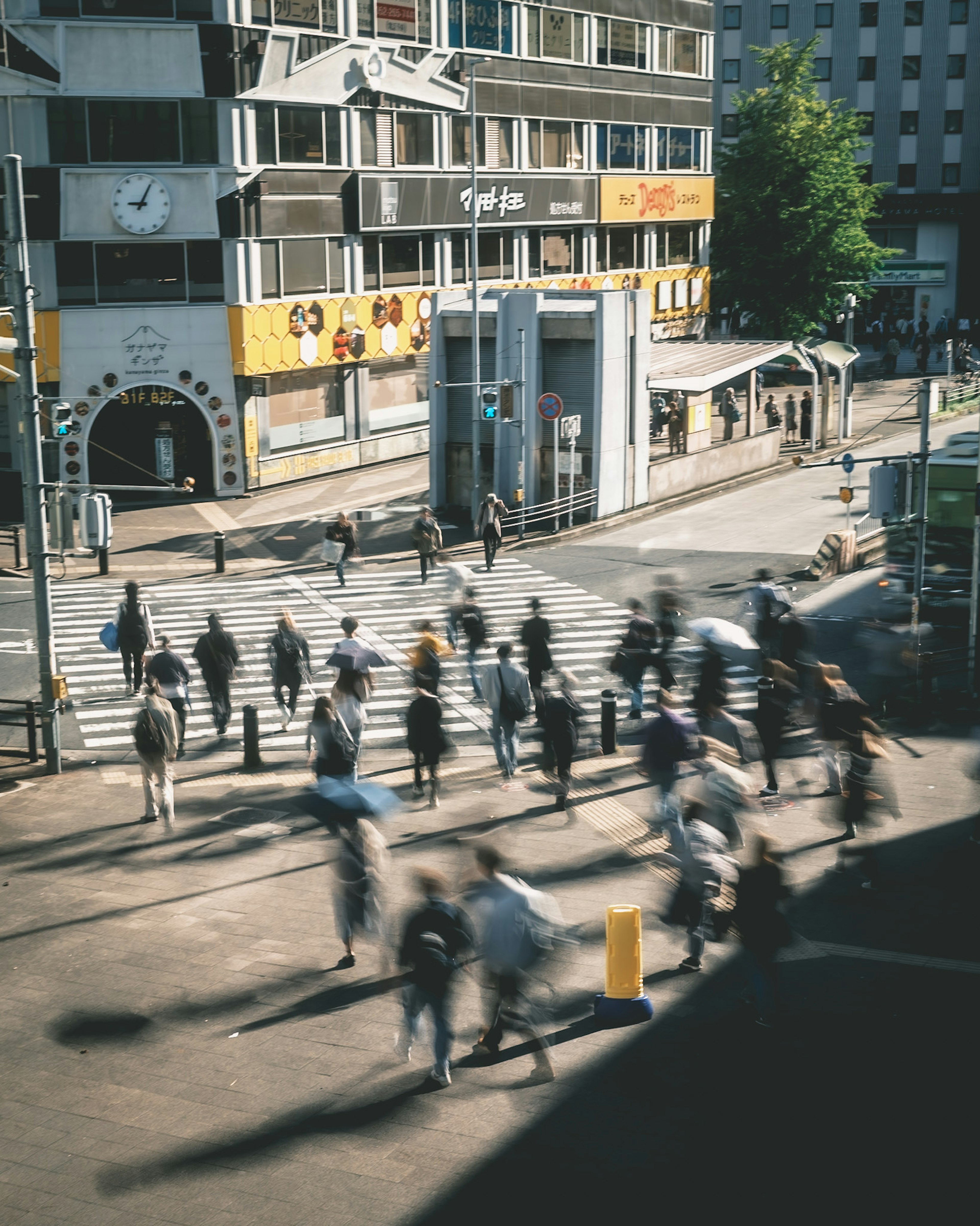 A bustling street scene in Tokyo with people crossing at an intersection