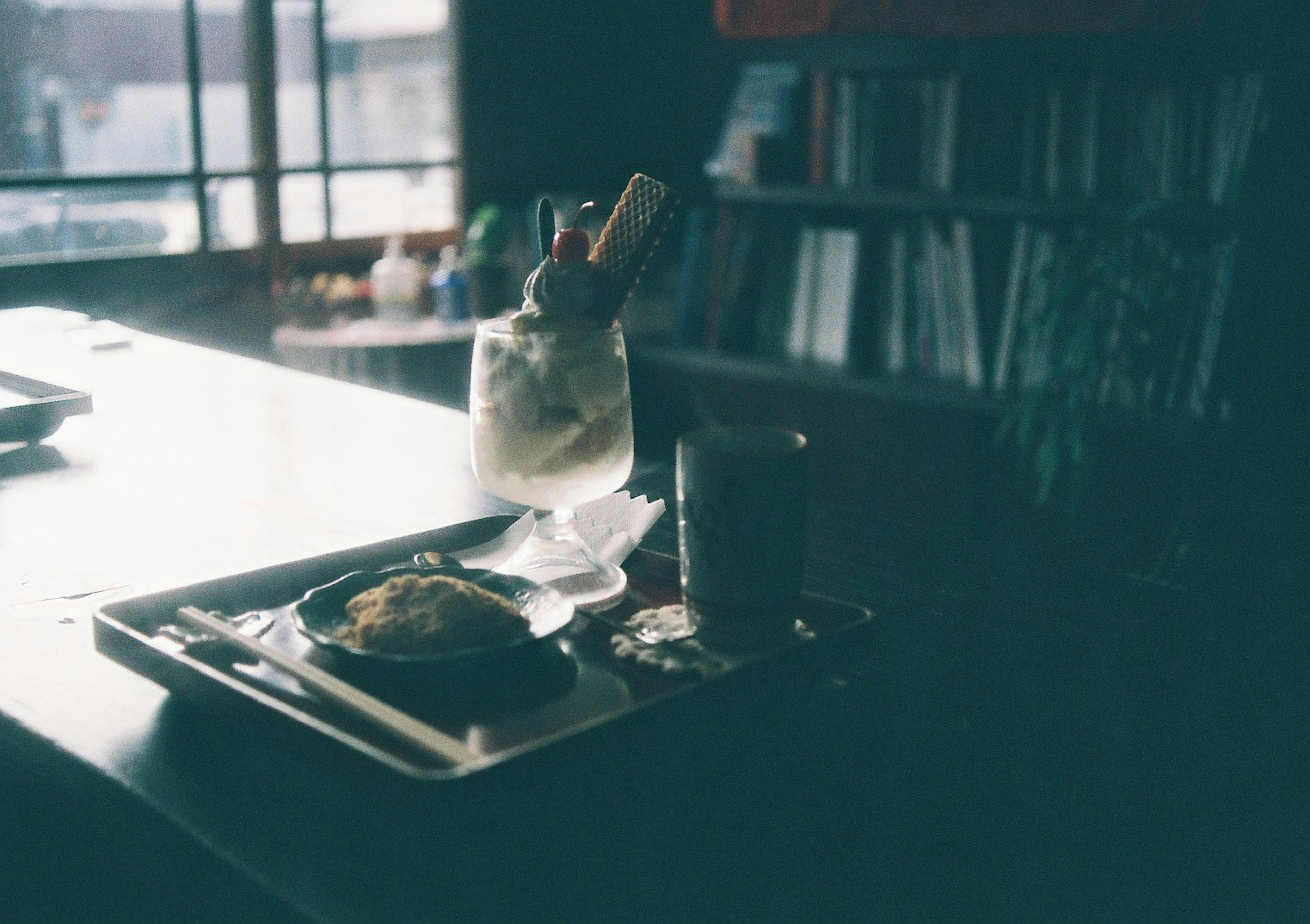 A photo of a dessert tray and drink on a table