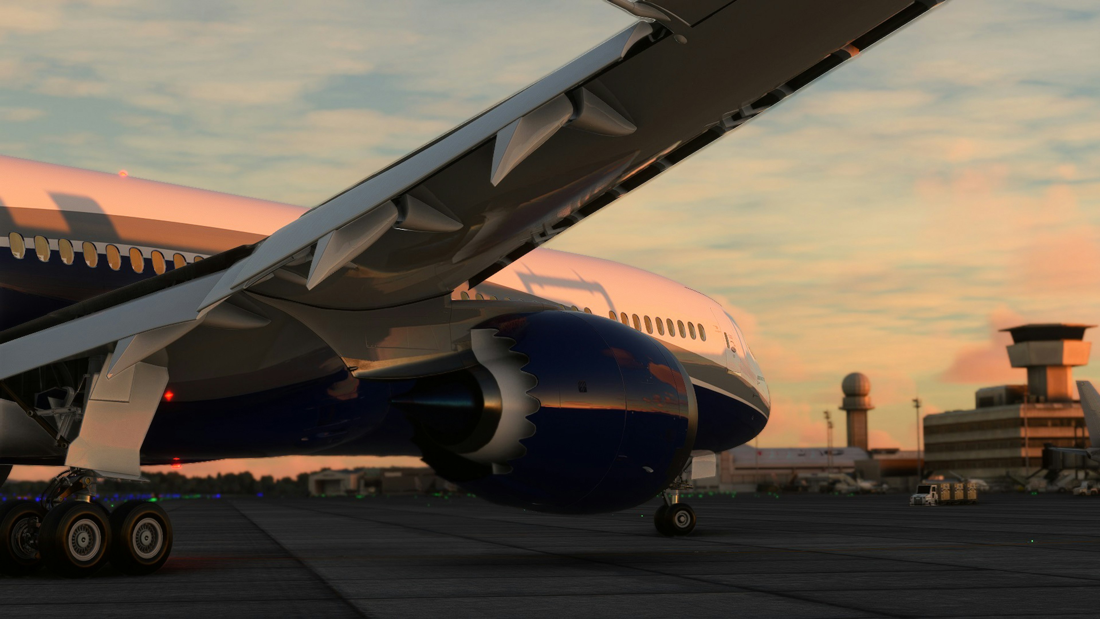 Airplane wing and engine illuminated by sunset airport terminal in the background