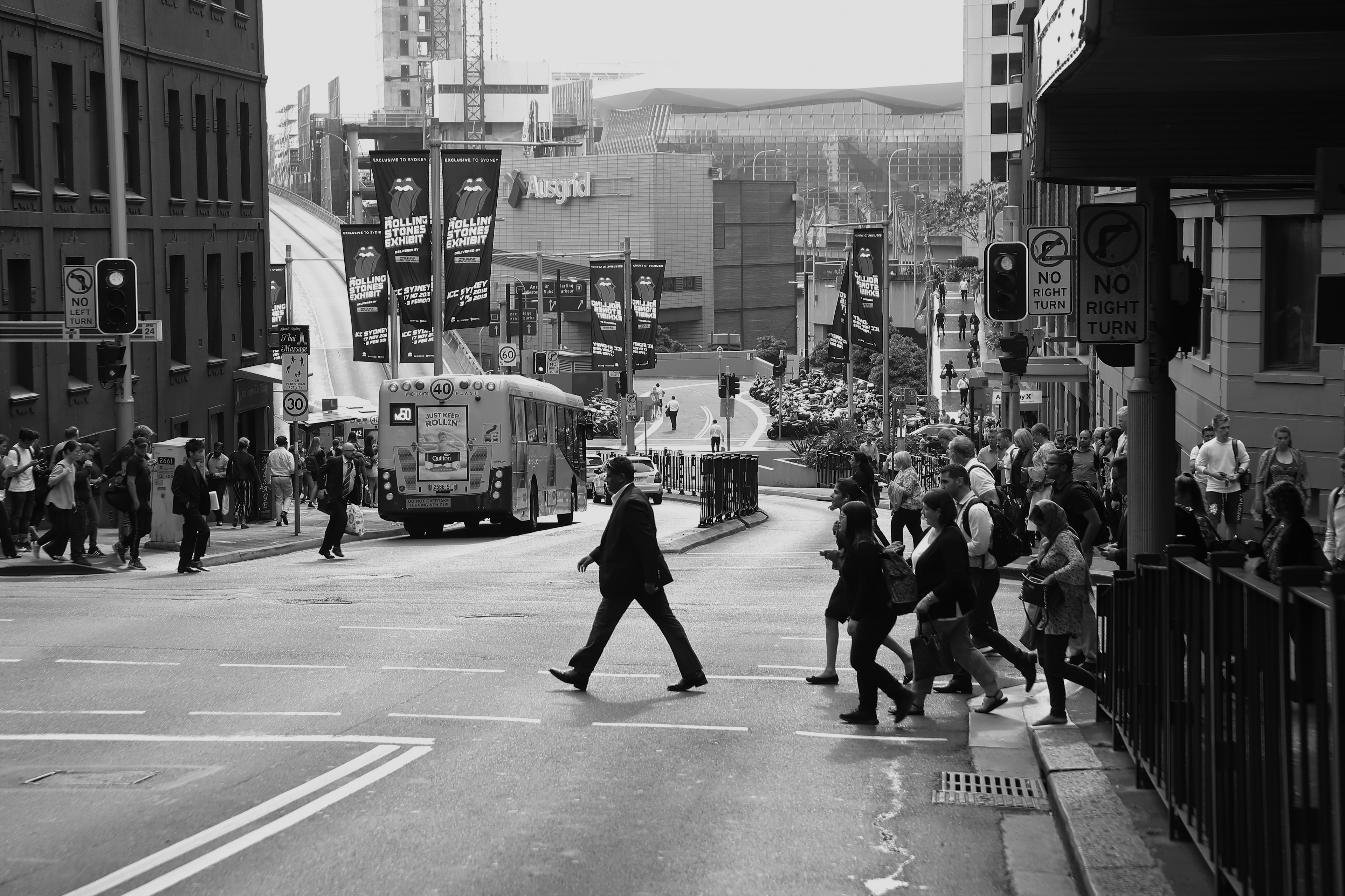 People crossing the street in a monochrome cityscape