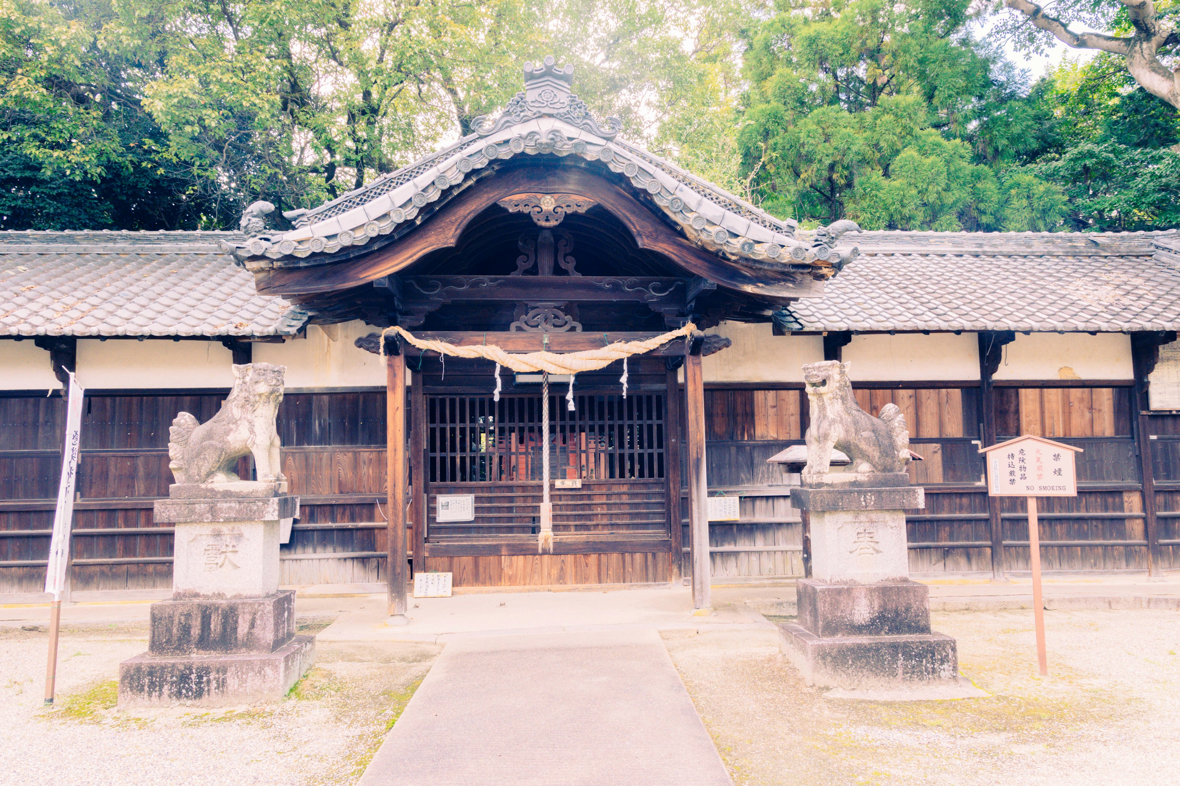 Entrance of a shrine featuring lion statues and traditional architecture