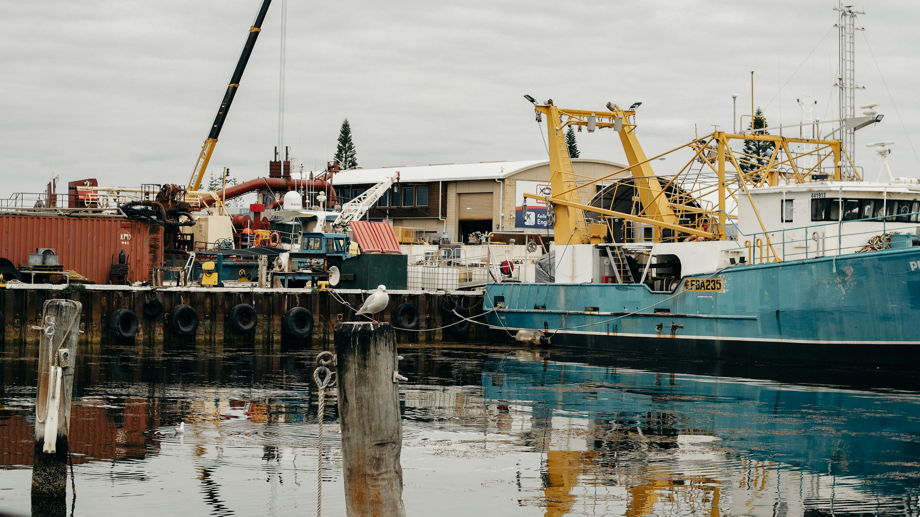 Fishing boats and cranes at a harbor scene